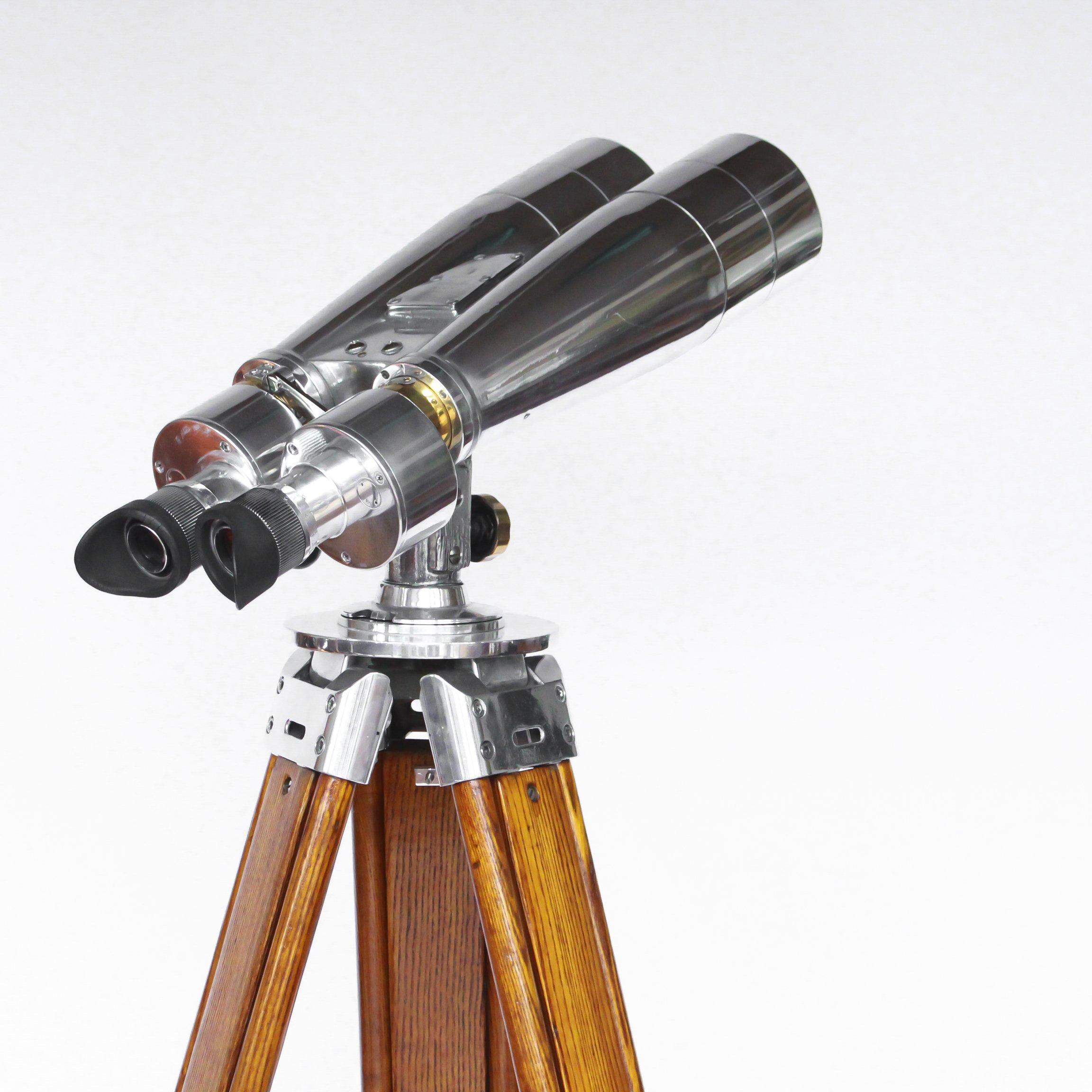 A pair of Fuji Meibo 15x80 marine binoculars on later extending wood and chrome stand with chromed conical feet. 15x magnification with 80mm objective lens.
Stamped Fuji Meibo and numbered

Dimensions: H 120cm - 190cm W 89cm D 35cm 

Origin:
