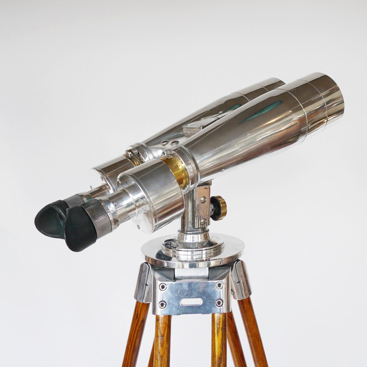 Fuji Meibo 15X80 marine binoculars on later extending wood and chromed metal stand with chromed conical feet. 15X magnification with 80m objective lens. 

Numbered 6526.

Stamped Fuji Meibo and numbered. 

Dimensions: H 50cm W 21cm Length 50cm