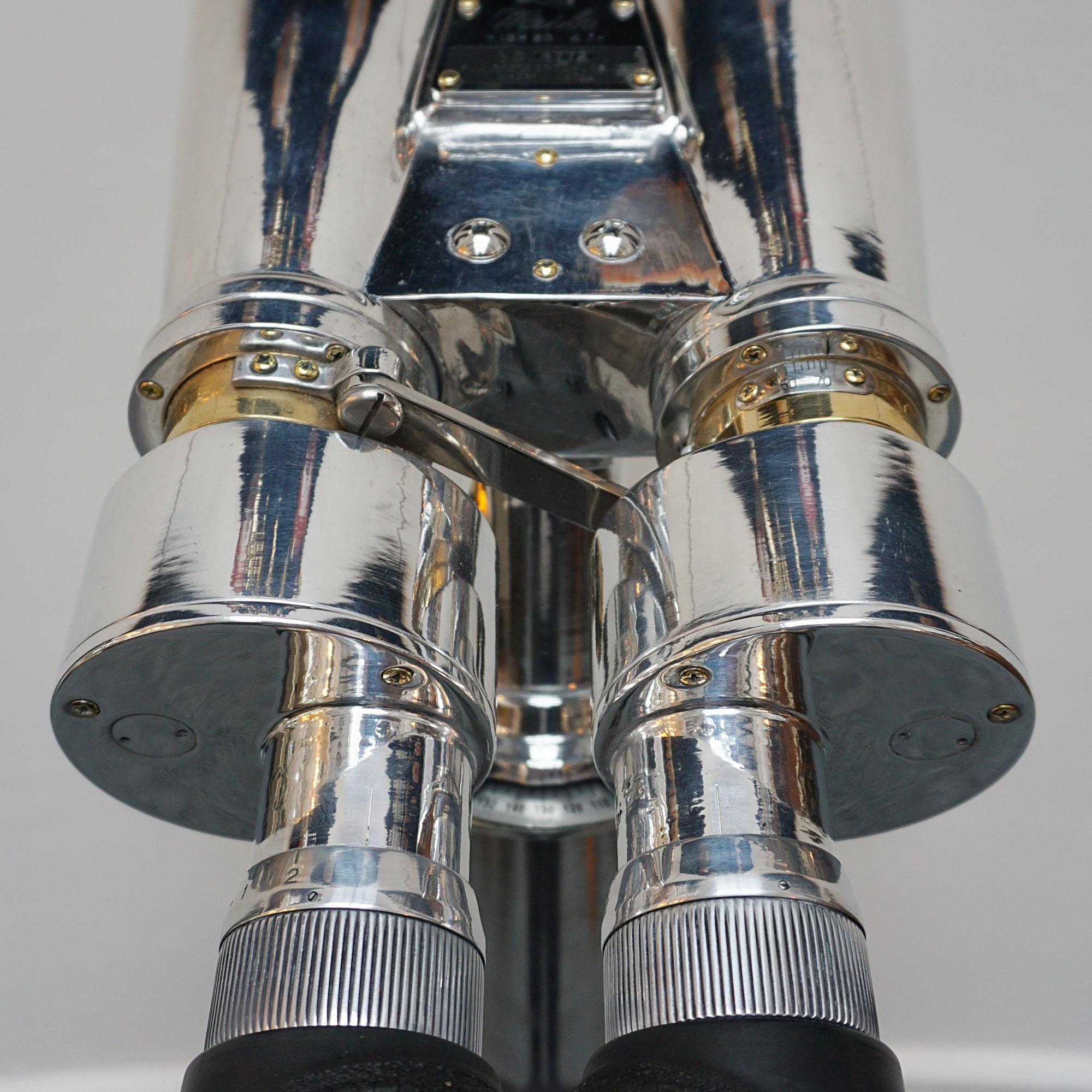 Fuji Meibo 15X80 marine binoculars on later extending wood and chromed metal stand with chromed conical feet. 15X magnification with 80m objective lens. 

Stamped Fuji Meibo and numbered. 

Dimensions: H 50cm W 21cm Length 50cm Stand H 100cm - 180cm