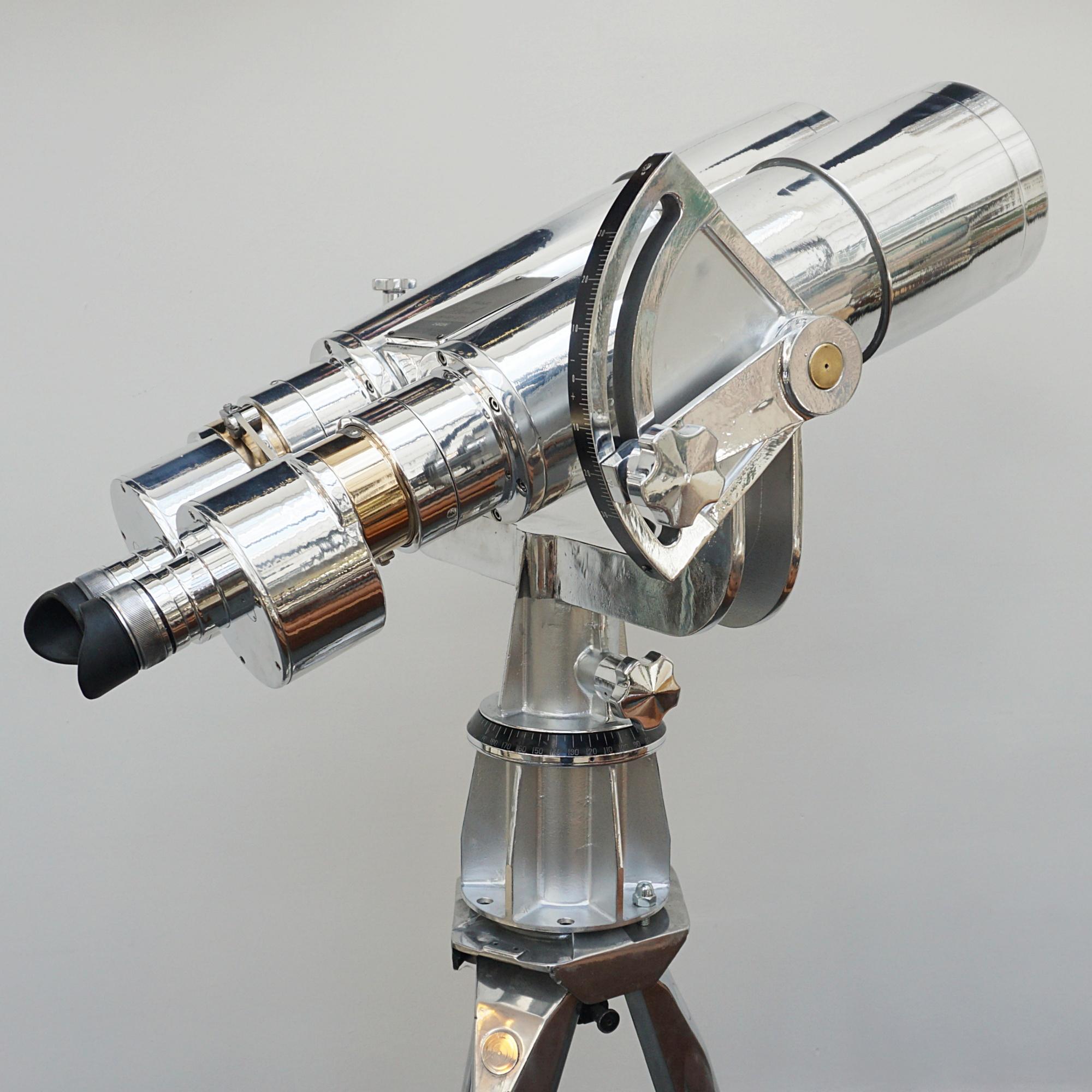 A large pair of chromed and polished metal and brass Fuji Meibo 25x150 Naval Binoculars. Set on a later impressive polished metal stand. Fuji Meibo 25x150 stamp to top. 

25x magnification with 150mm objective lenses. Paint stripped and metal
