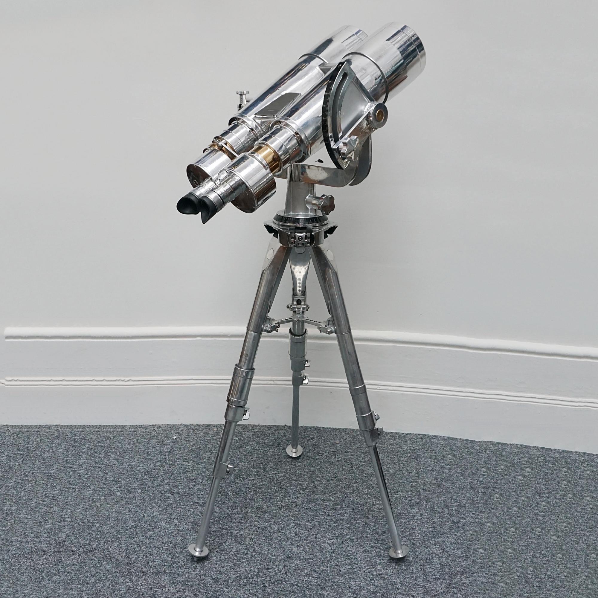 A large pair of chromed and polished metal and brass Fuji Meibo 25x150 Naval Binoculars. Set on a later impressive polished metal stand. Fuji Meibo 25x150 stamp to top. 

25x magnification with 150mm objective lenses. Paint stripped and metal