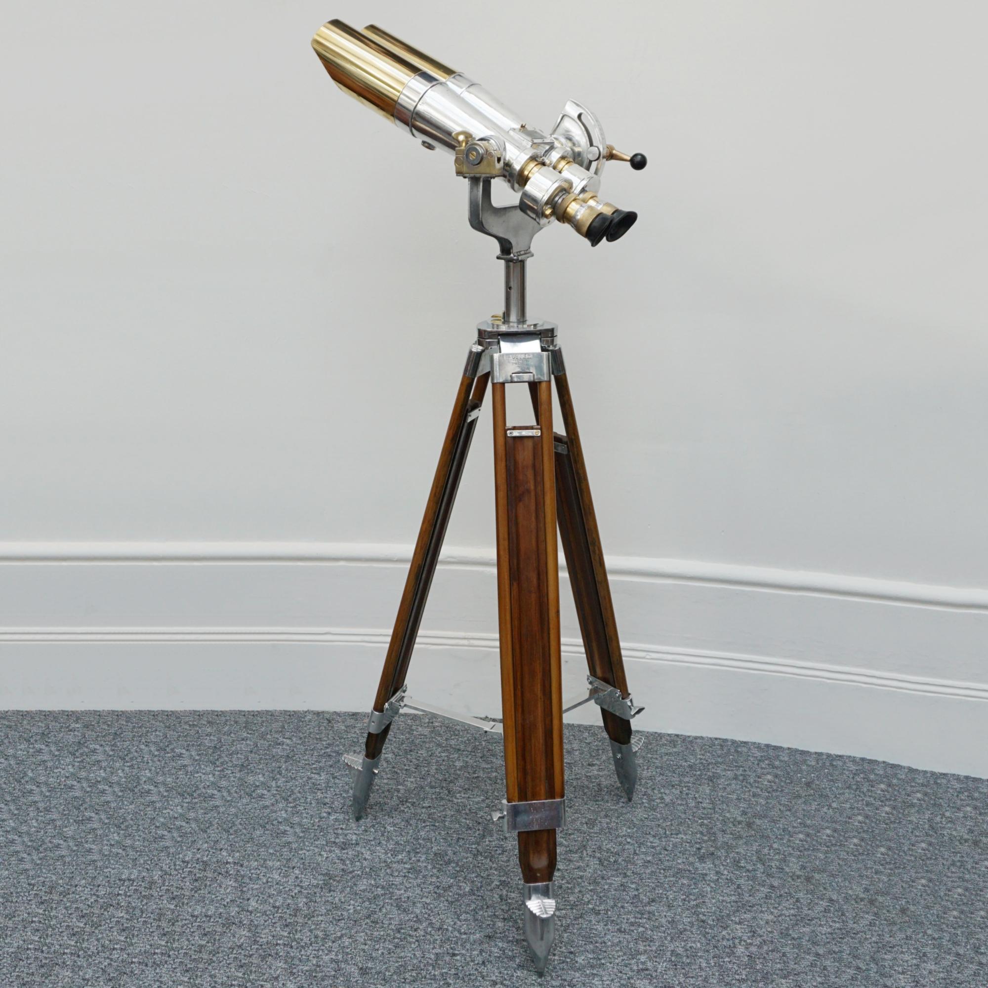 Early Fuji Meibo 15X80 chrome and brass marine binoculars on later extending wood and chromed metal stand with chromed conical feet. 15X magnification with 80mm objective lens. 

Dimensions: H from stand 30cm W 36cm Length 63cm Stand H 100cm - 180cm