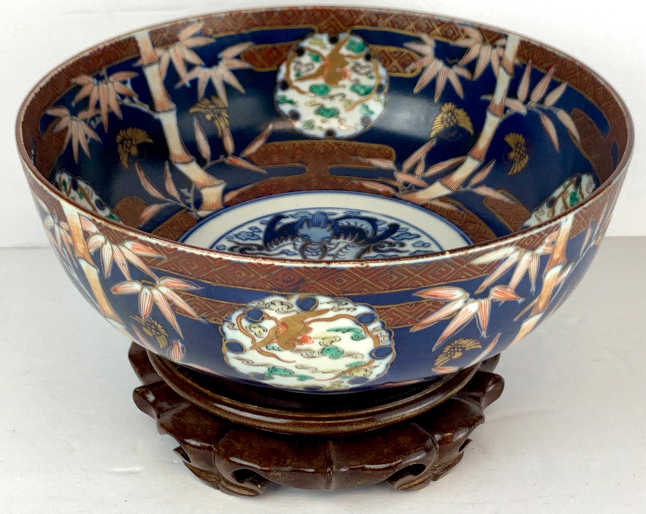 Fukagawa Imari blue background bowl and stand, beautifully decorated with bamboo motif with medallion with dragon. Marked with iron red Fukagawa mark. Complete with 6.5