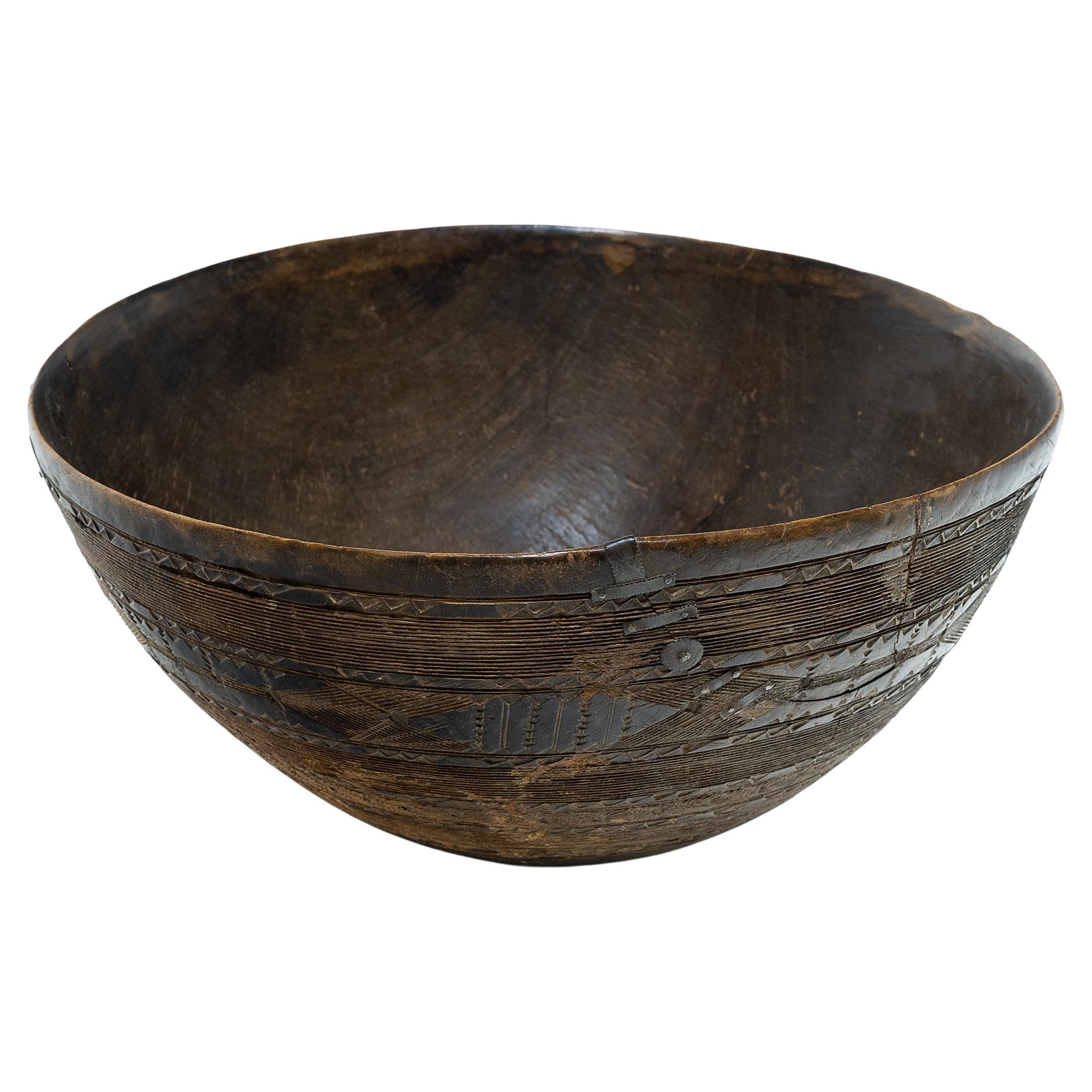 This carefully incised wooden bowl originally belonged to a Fulani family, a Muslim culture scattered throughout West Africa. Because the Fulani are frequently nomadic, they rely on neighboring cultures for the production of many of their objects.
