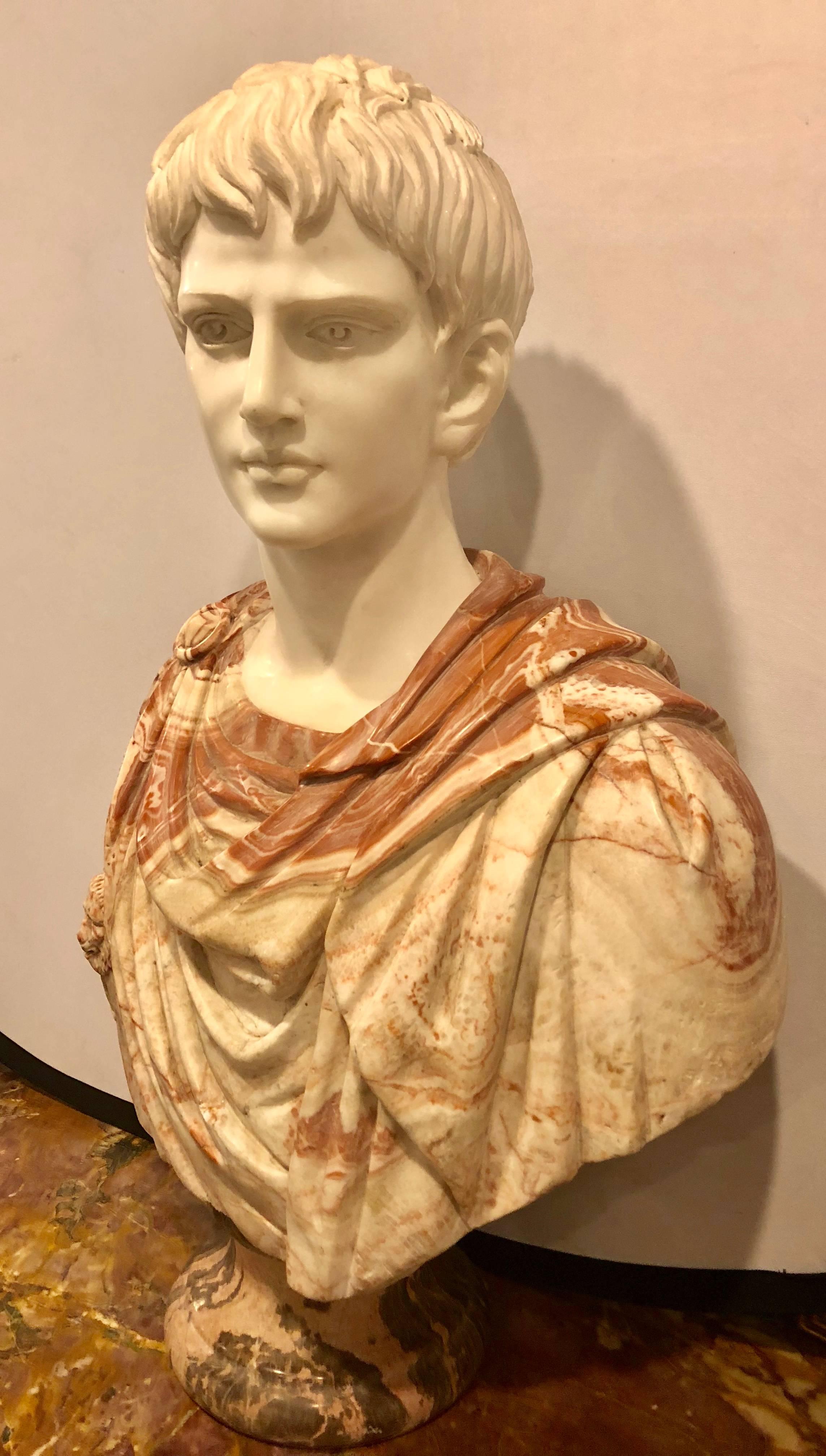 A full colorful marble bust of a young roman. This large and impressive bust is certain to make an impression as one views the fine detail and enormity of the sculpture.