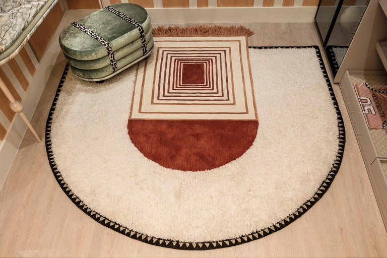 The Full court tapestry rug experiments with the depiction of the court floor with strong repetitive forms that are softened by dawn-inspired neutrals. This rug is hand-tufted in India, made with wool, silk, and shag. Each piece is an imaginative