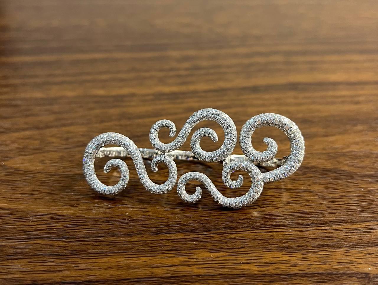 Elegant Diamond Swirl Full Finger Hand Knuckle Ring . This exquisite Ring features a series of intricate swirling patterns encrusted with shimmering diamonds of F/VS Quality and 3.5 CTW. The design is fluid and graceful, capturing light beautifully.