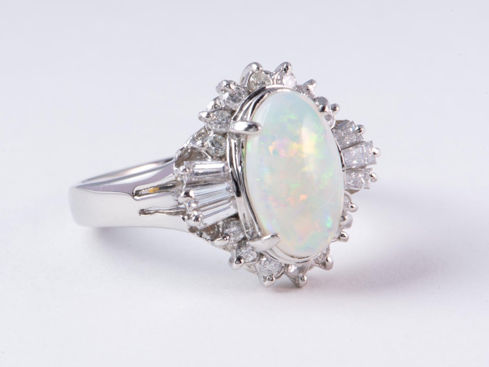 ♥ Full of Fire Australian Opal with Diamond Halo Platinum Engagement Ring 7g V1159
♥ This is a gorgeous ring set with a beautiful Australian opal in the center, surrounded by 0.43ctw worth of diamonds on the band.
♥ The item measures 15.1mm in