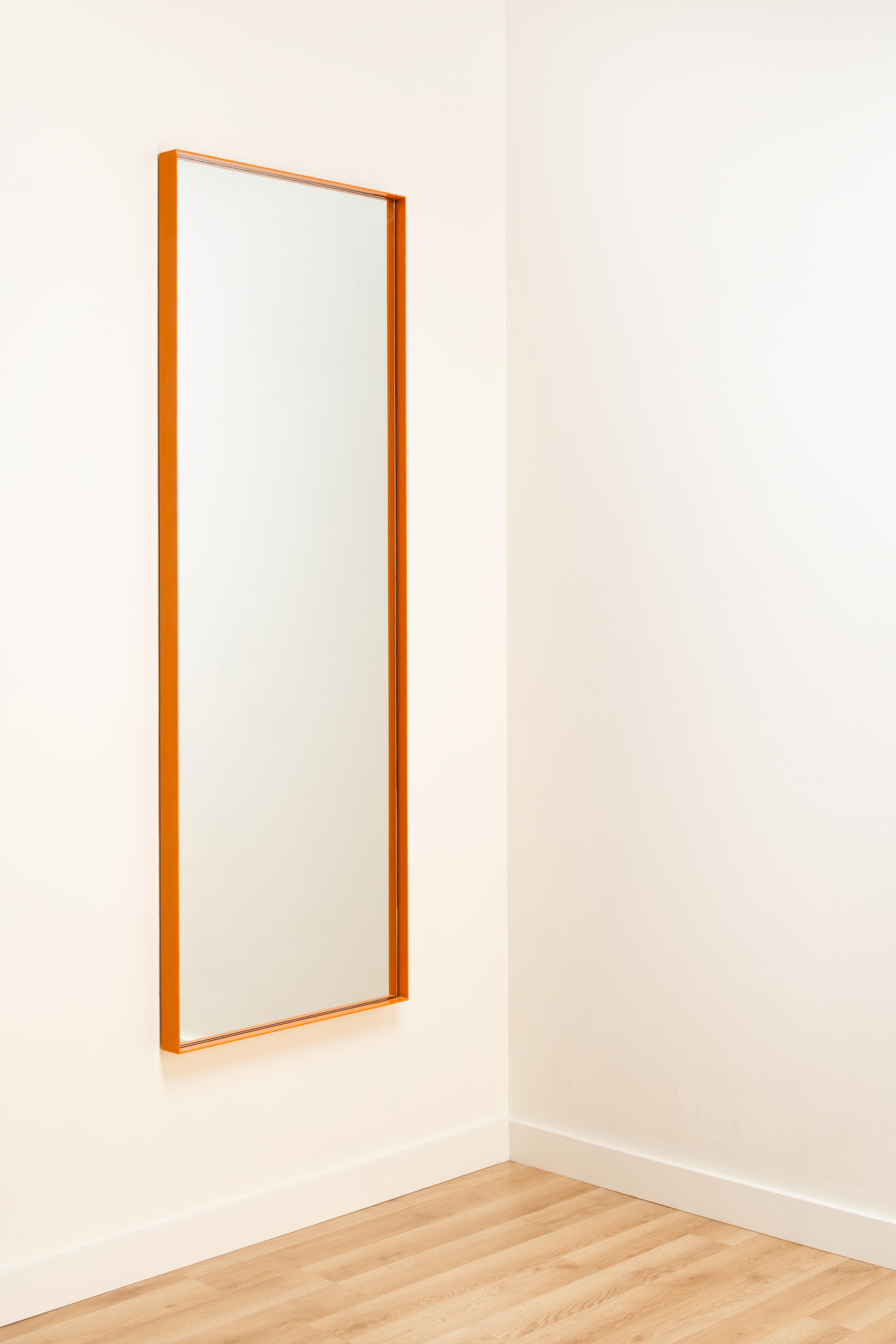 A glossy, powder-coated steel frame with glass mirror and hardwood ply backer board.  

Handmade in Chicago to exacting specifications.  

Let us know your ideal size and finish and our team will handle the rest.  See finishes page.  Inquire for max
