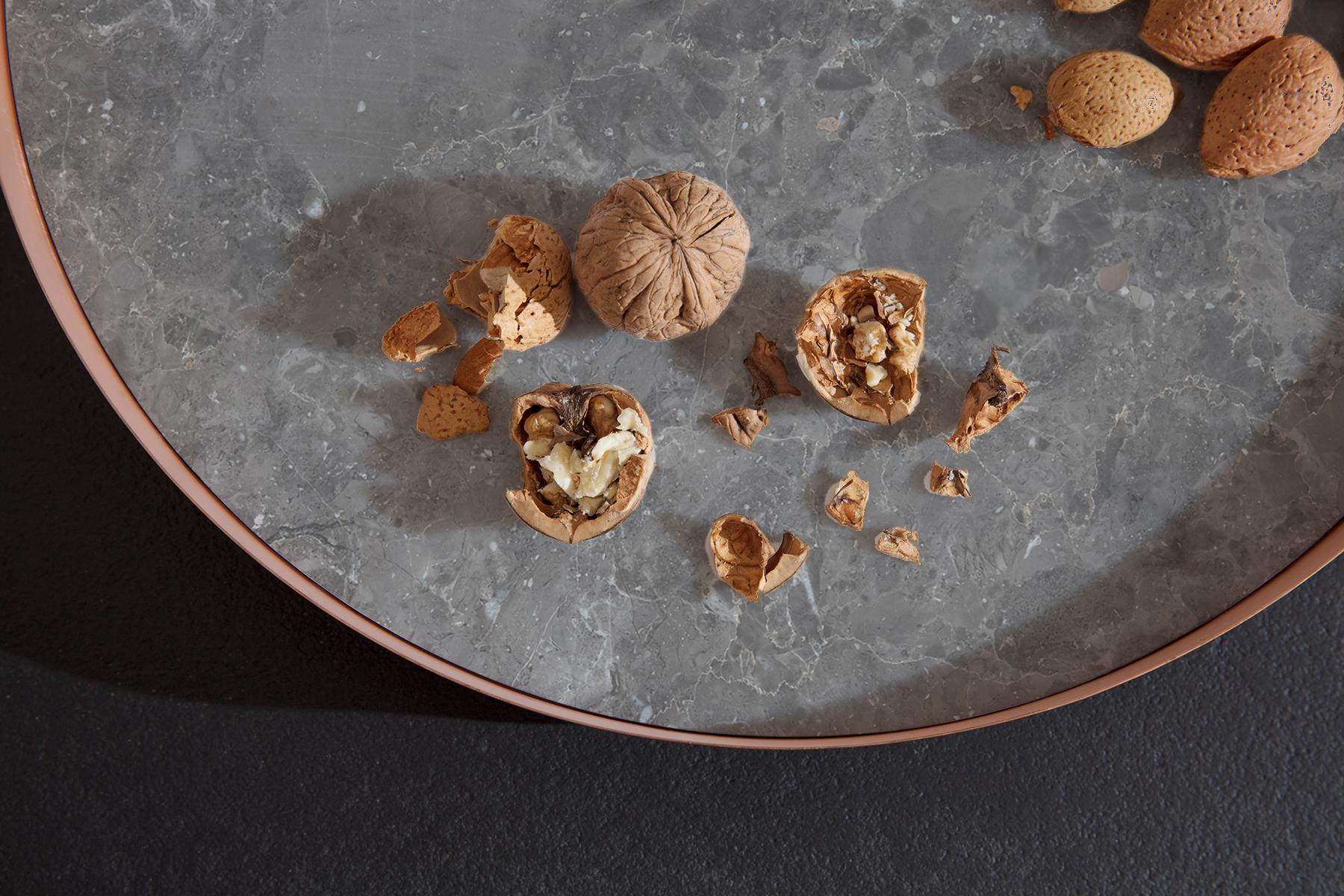 Full Moon is a large copper tray with a Gris du Marais marble top, a variety of grey marble with white and - sometimes- rust veins. The hot tone of copper perfectly blend with the tones of the marble, a pure geometric shape perfect for displaying