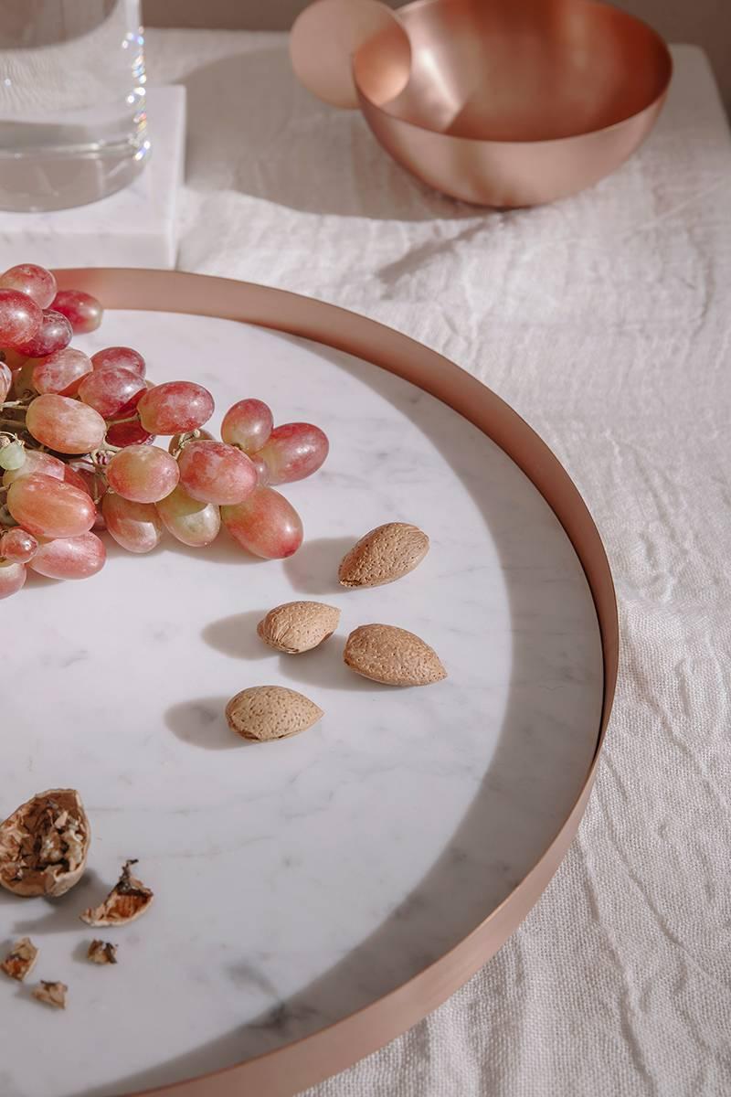 Full moon is a circular copper tray with a Carrara marble top and it is part of the Lunar Landscape collection designed by Elisa Ossino, who conceived for Paola C. a tableware collection, revisiting the classic themes of mise en place and the