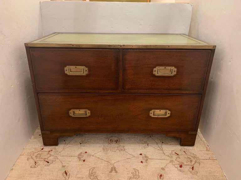 Full of old world character, a Campaign style chest of drawers having brass recessed hardware and fabulous weathered green tooled leather top.
Found in Nantucket.

Measures: 36” W x 18” D x 24.5” H.