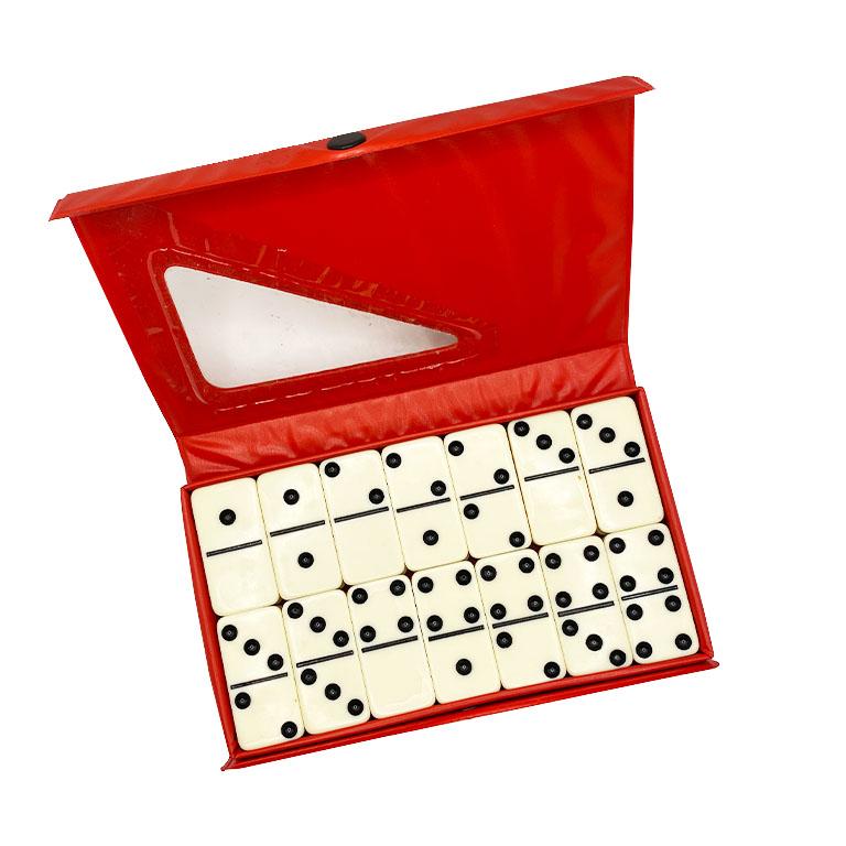 Complete set of black and white Bakelite dominoes. In original packaging.

Each domino is a creamy white with black accents. A great way to pass time on the patio with family and friends. See our game table listing to add a fabulous touch to your