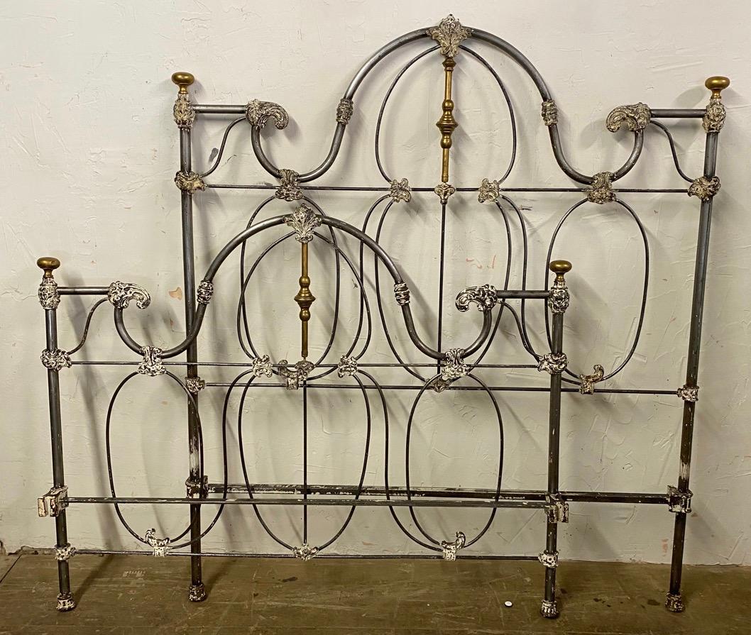 Wonderfully stylish full size brass and cast iron bed with cast metal decoration and a touch of gold finishing on the decorations. 
Foot board = 54