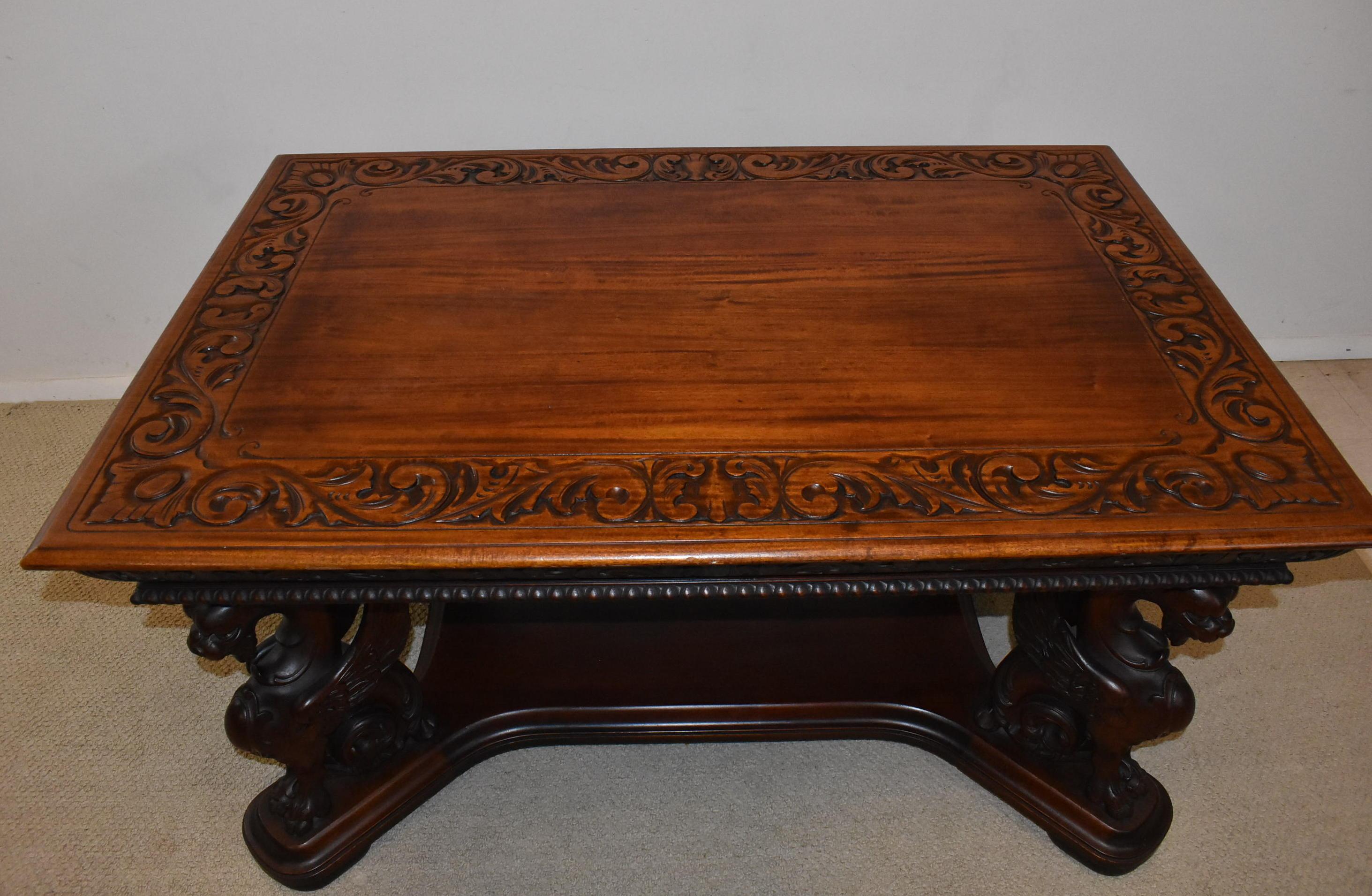 Full standing mahogany winged griffins partners desk by Horner. Two dove tailed drawers. Great condition with old finish. Carved desk top border.