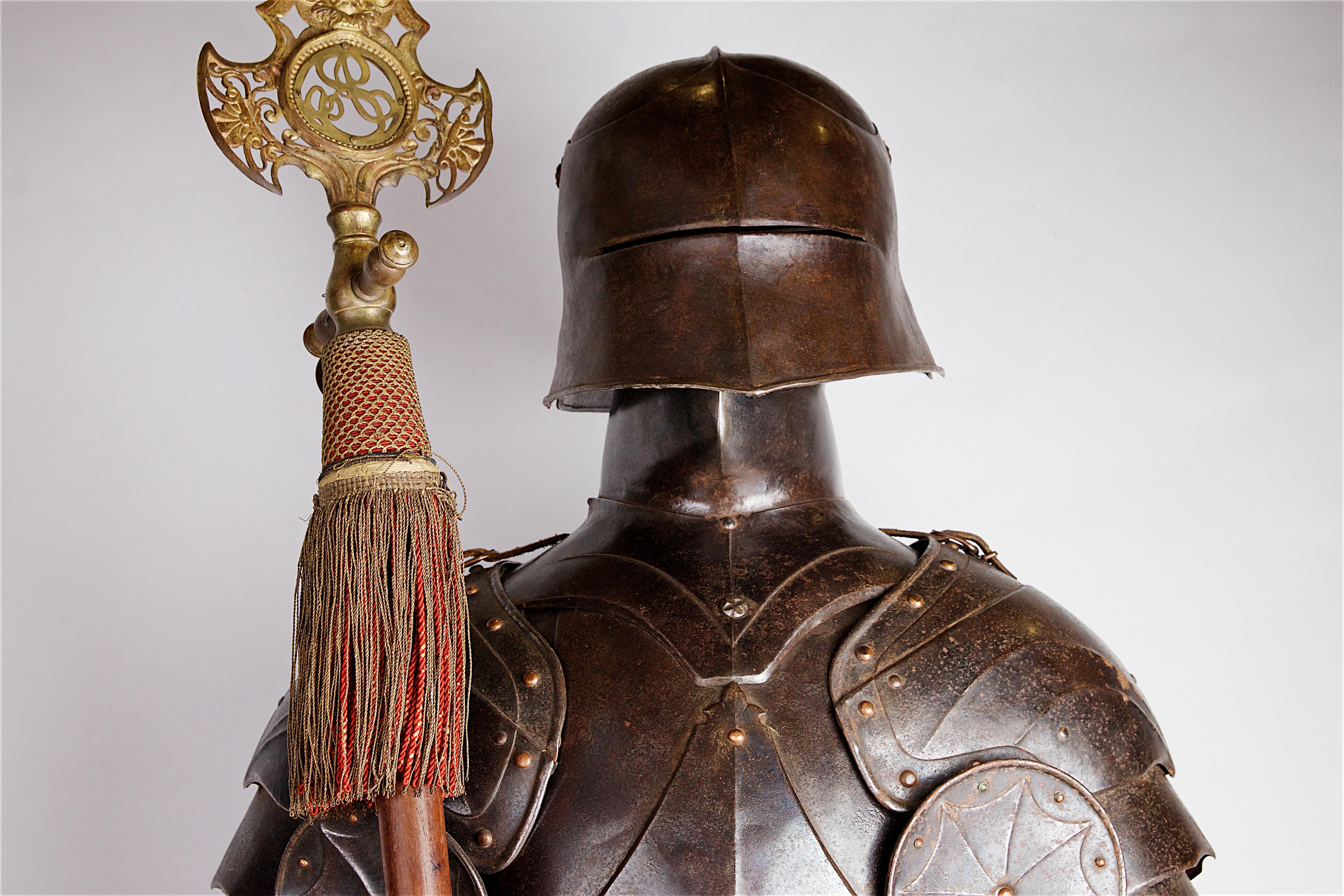 A full suit of gothic style armour in the style of circa 1480, English
Mounted on wooden plinth.