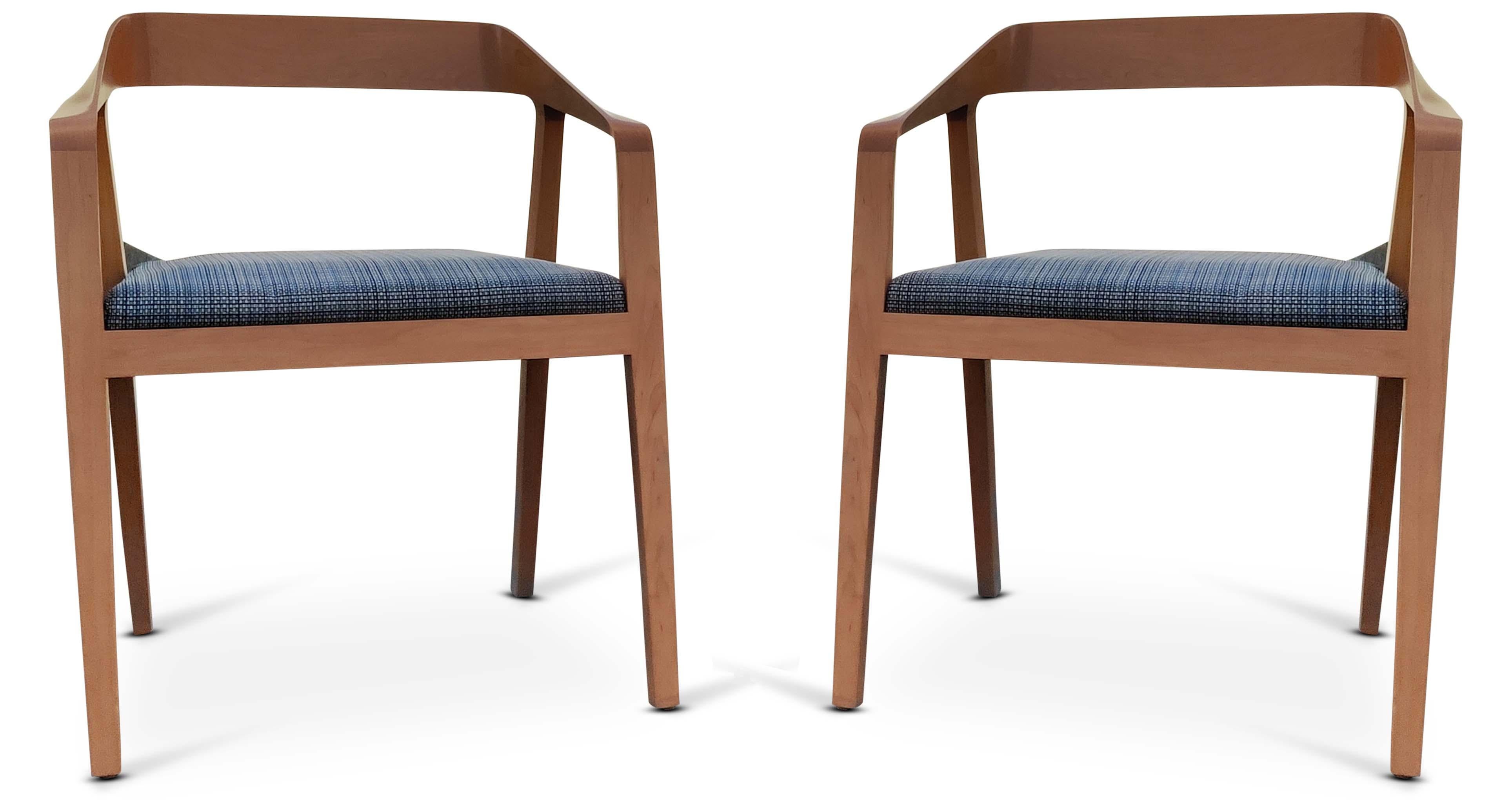 This pair of chairs was designed with a masterful eye. The solid ash wood construction has very modern and sleek lines, twisting and turning. The pieces of the frame meld together, with sculpted ribbons of wood that flow seamlessly from the front
