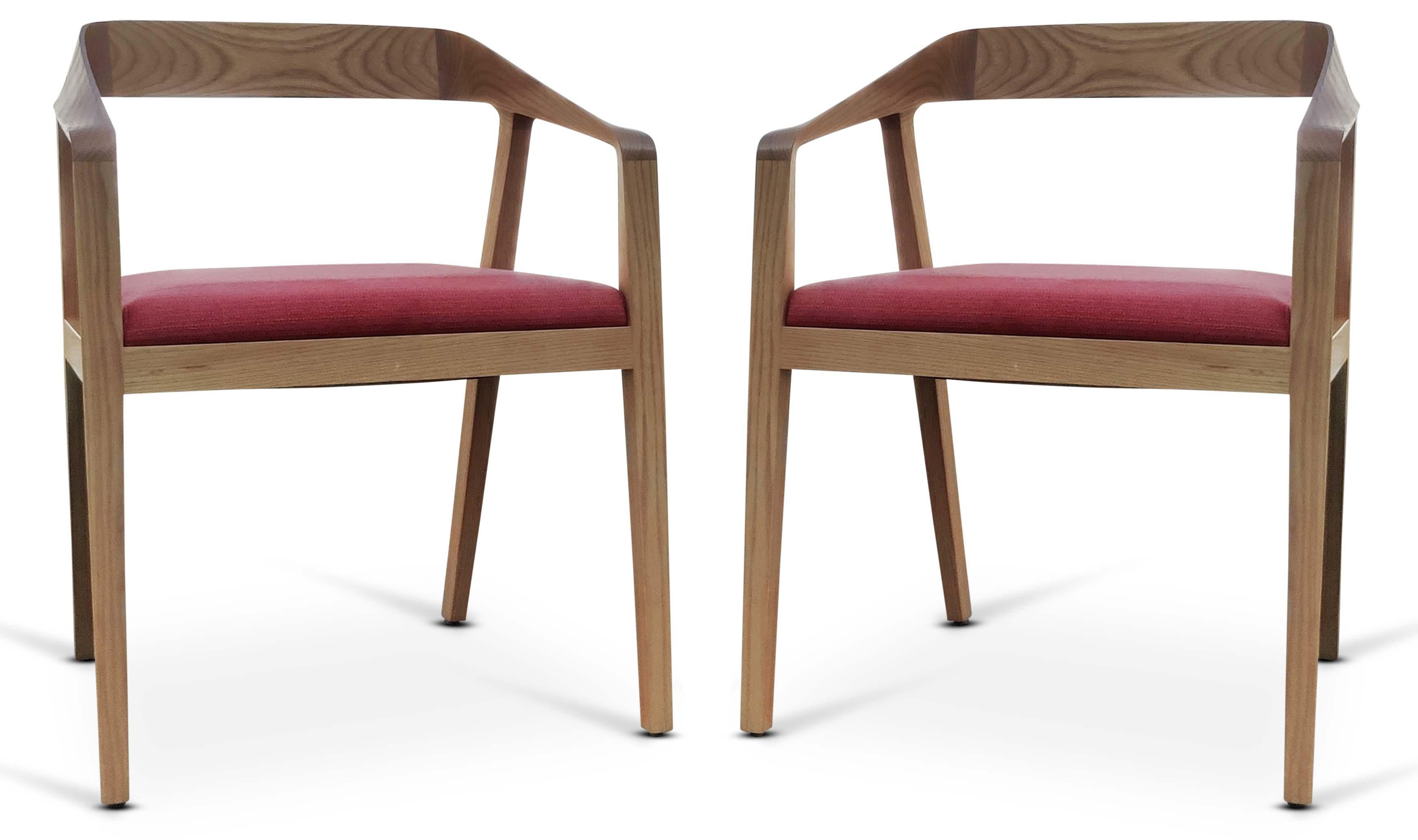This pair of chairs was designed with a masterful eye. The solid maple wood construction has very modern and sleek lines, twisting and turning. The pieces of the frame meld together, with sculpted ribbons of wood that flow seamlessly from the front