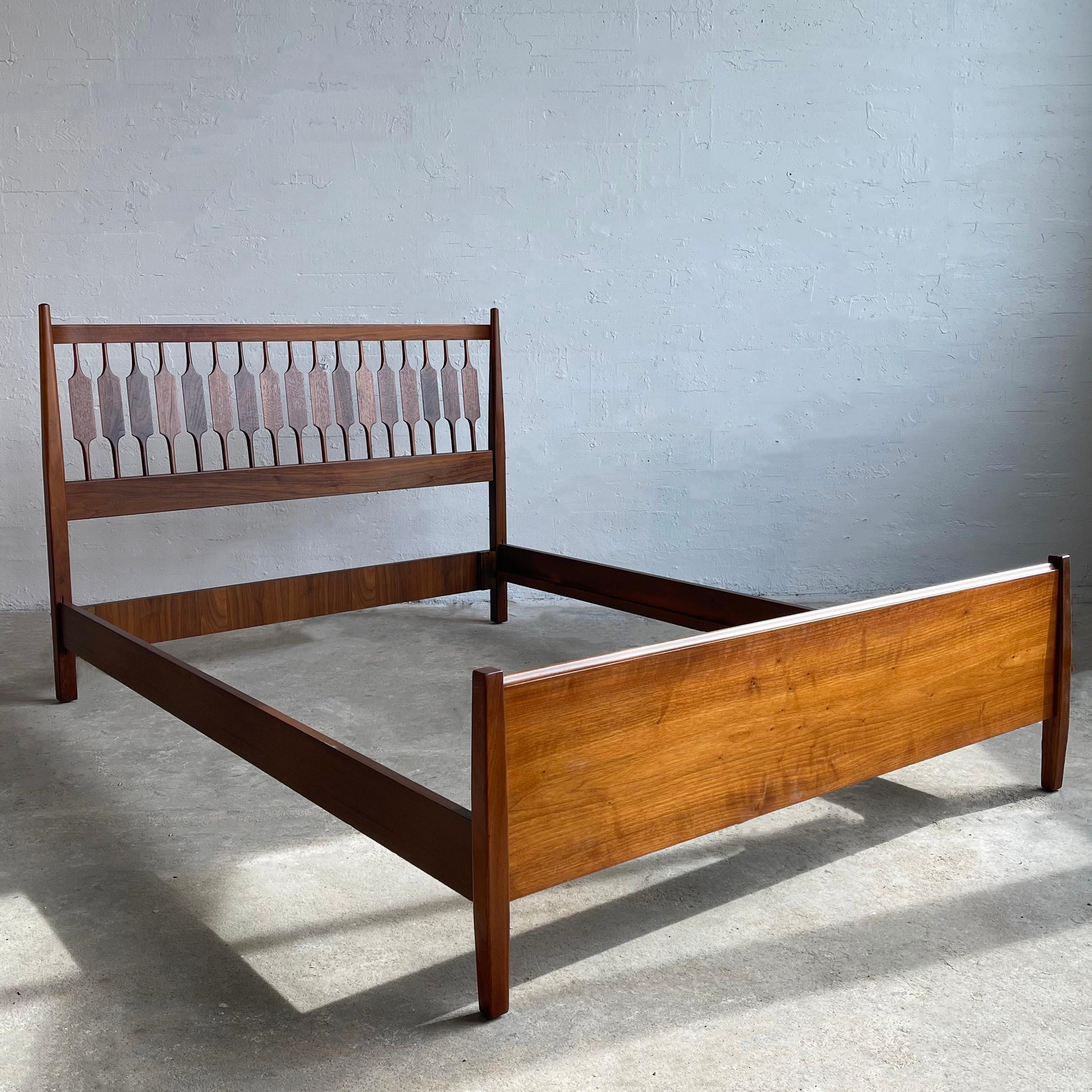 Mid-century modern, full size, black walnut bed designed by Kipp Stewart & Stewart McDougall for Drexel Declaration. The headboard features a decorative slat panel with a solid footboard and side rails included. 