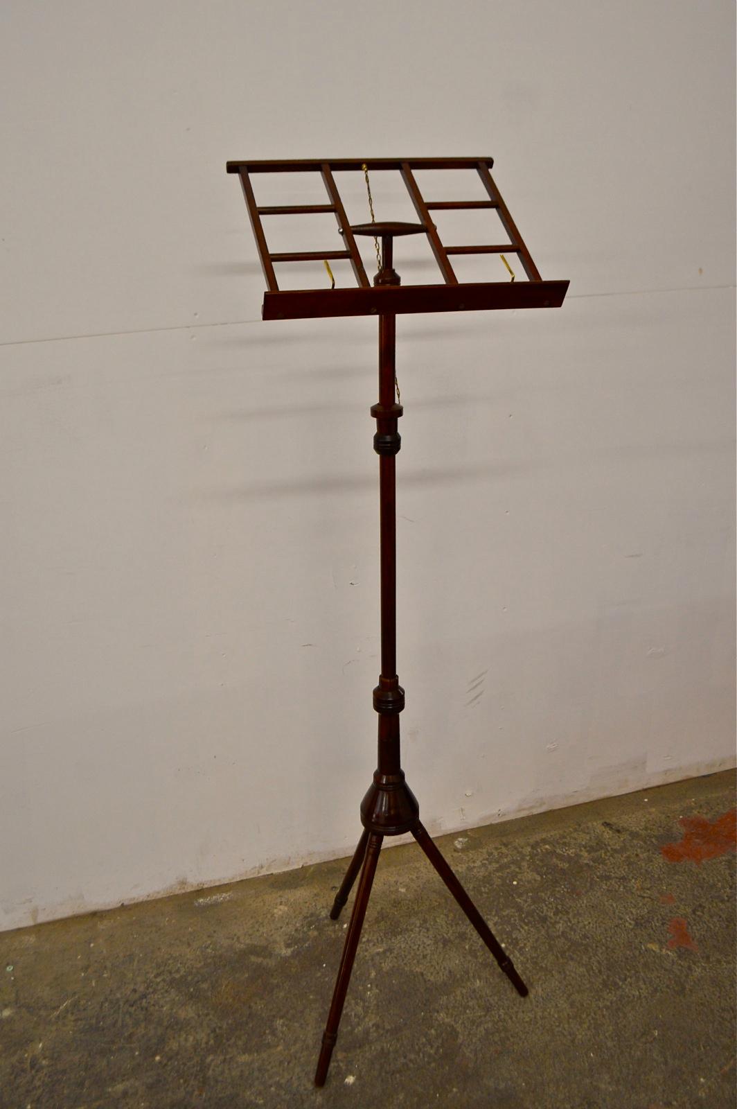 A beautifully crafted and presented Regency period antique music stand that is fully adjustable from vertical to horizontal for book holding. The book shelf measures 40cm x 40cm and is fitted with two brass page stoppers, that stop the pages from