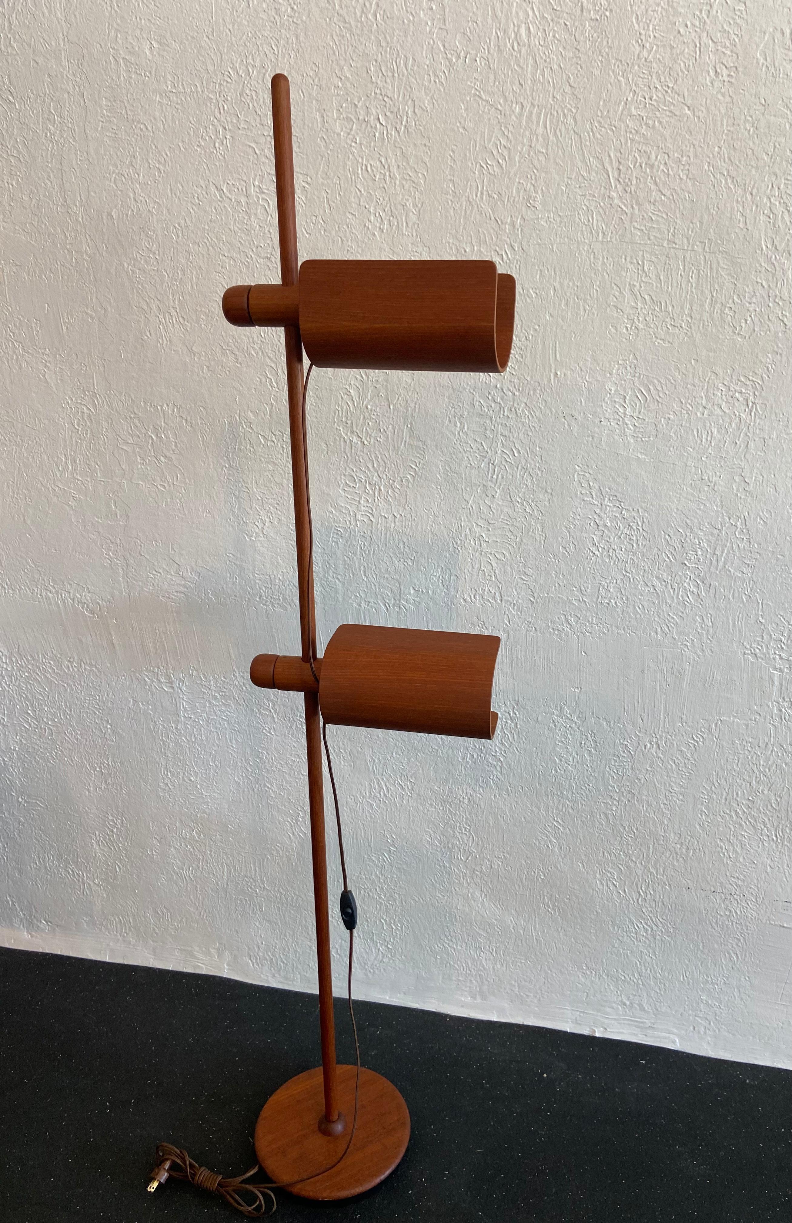 Fully adjustable German made teak floor lamp. Newly rewired with silk cord. Last two photos show repair on plastic bulb housing (please refer to photos).

Would work well in a variety of interiors such as modern, mid century modern, Hollywood