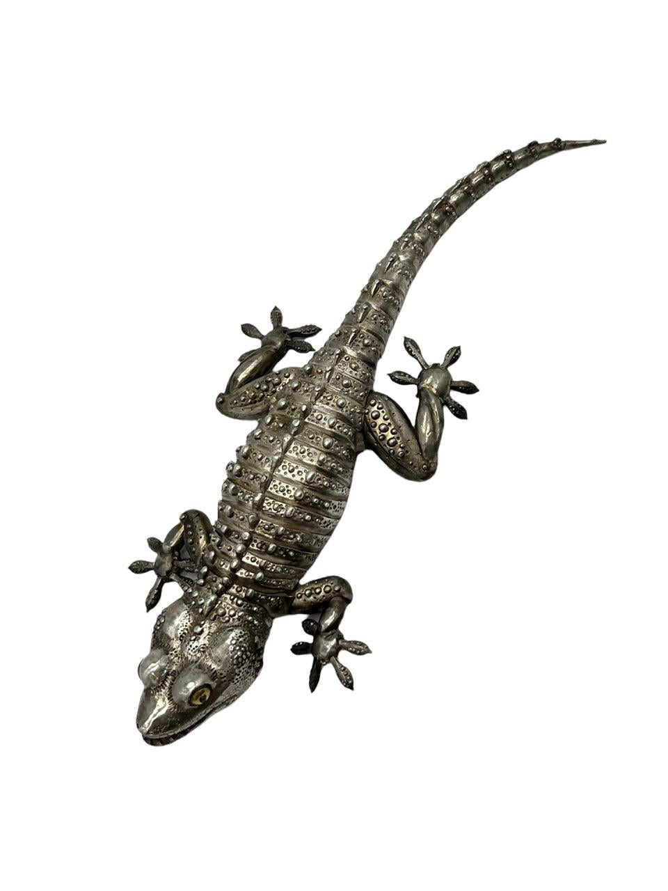 21st century fully articulated gecko made of sterling silver by artist Oleg Konstantinov. It is realistically modeled with gold eyes and articulated body. 
 