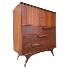Fully Refinished Mid Century Modern Sculpted Highboy Dresser. Circa 1960s