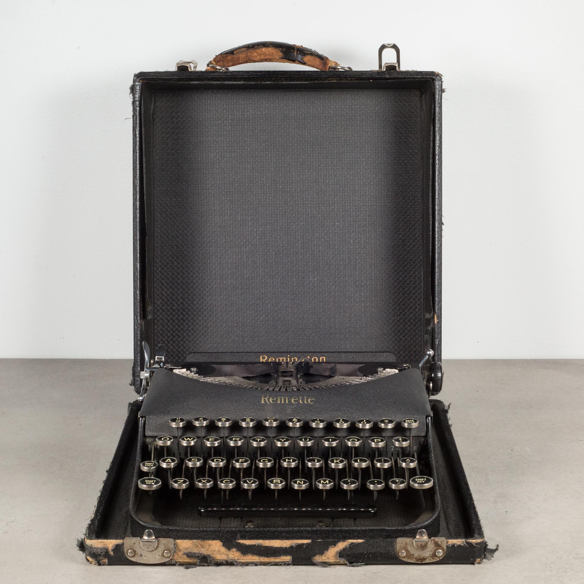 An original Remington Remette Typewriter in matte black with original case. The keys are nickle with white letters on a black background. This typewriter is very clean and in good working order. It has smooth typing and the carriage advances and