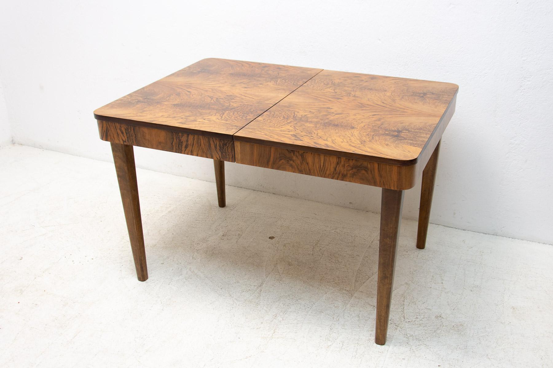This adjustable dining table was designed by Jindrich Halabala and made in the 1940s in the former Czechoslovakia. The table is in ART DECO style and was fully renovated to high gloss finish.

The material is a combination of solid wood and walnut