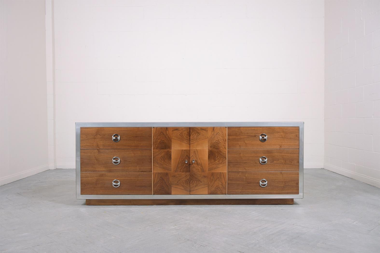 Step into the stylish world of the 1960s with our exquisitely restored mid-century modern chest of drawers. This vintage dresser revived with great care and attention to detail, showcases the exceptional quality of its walnut wood construction,