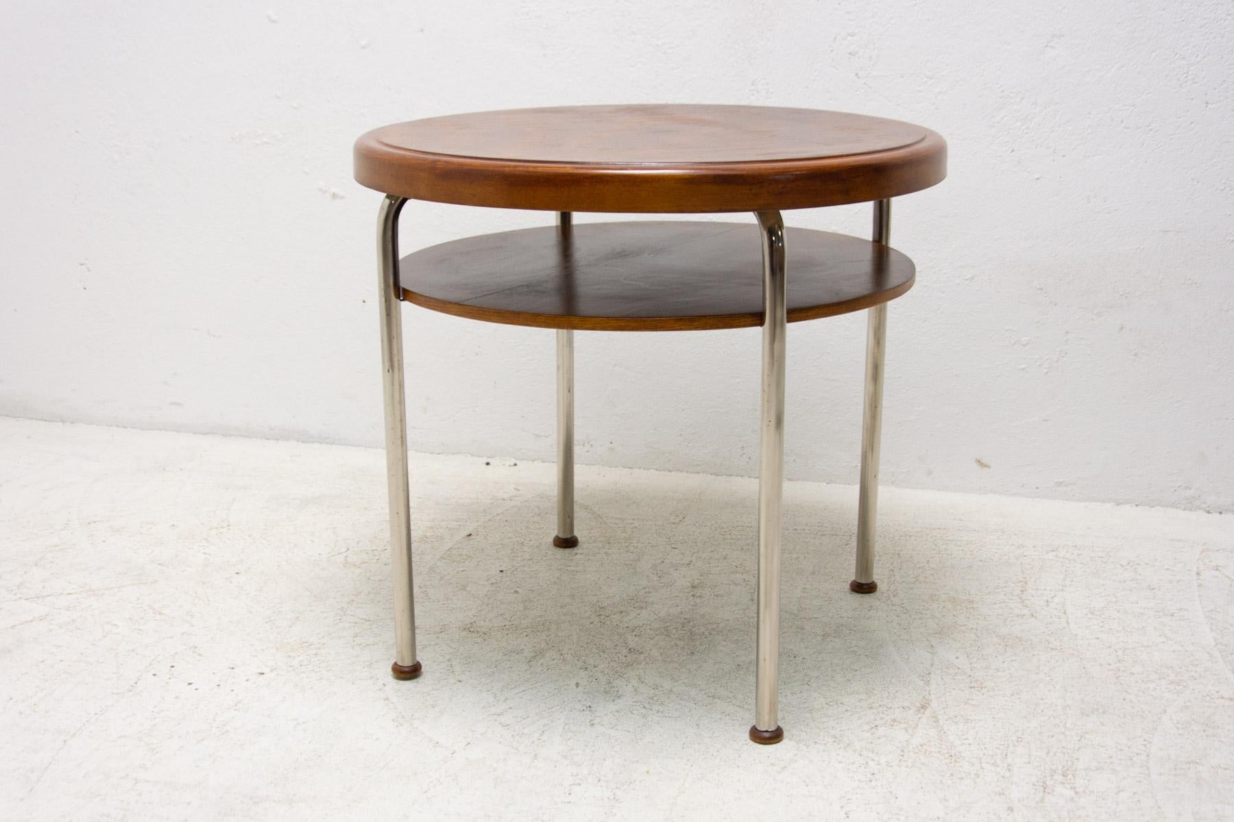 This coffee table was designed by Robert Slezák and made in the former Czechoslovakia in the 1930´s.

The table has a chrome-plated metal base and walnut wood tops. Chrome structure is in very good Vintage condition. The wood was fully