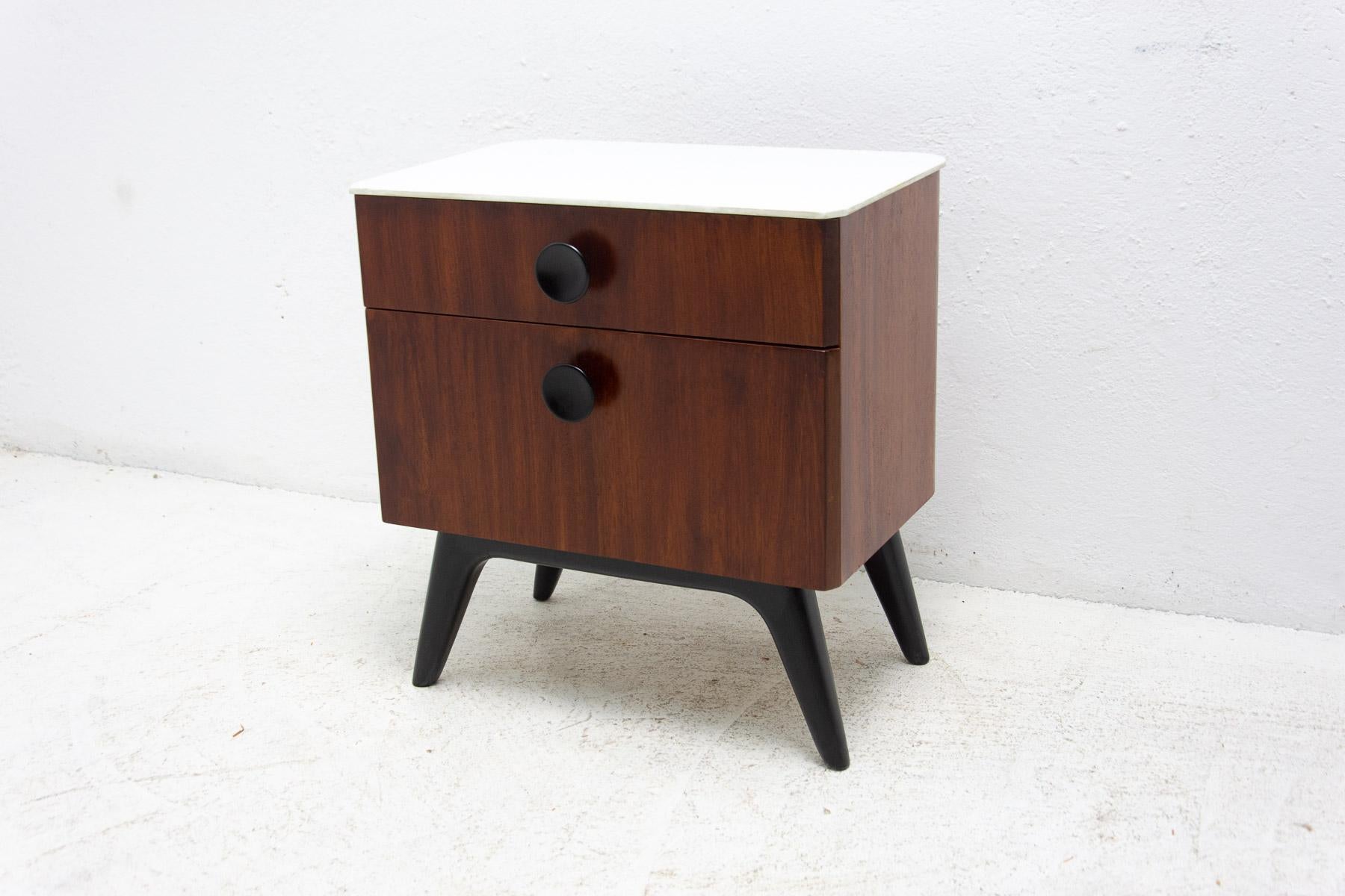 This bedside table can be used also as a small chest of drawers. It was designed by Jindrich Halabala for UP Závody in the former Czechoslovakia in the 1950´s. It has one drawer and storage space at the bottom. White glass on the top. Material: