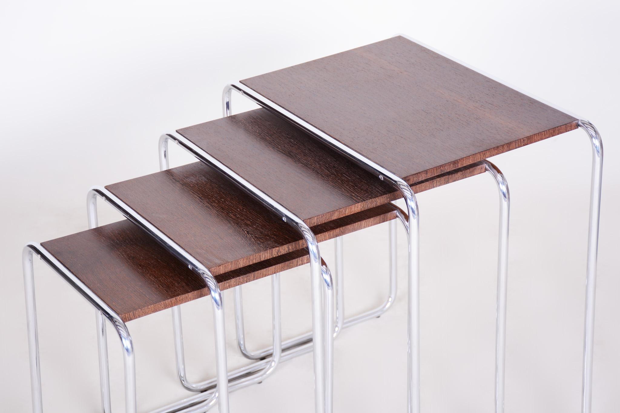 Beautiful Brown Nest tables made in the 1950s, they are made out of lacquered wood and chrome plated steel. 
Made by Kovona

Dimensions of the biggest piece: 
Height: 59 cm (23.23 in)
Width: 56,5 cm (22.24 in)
Depth: 37 cm (14.57 in).
 