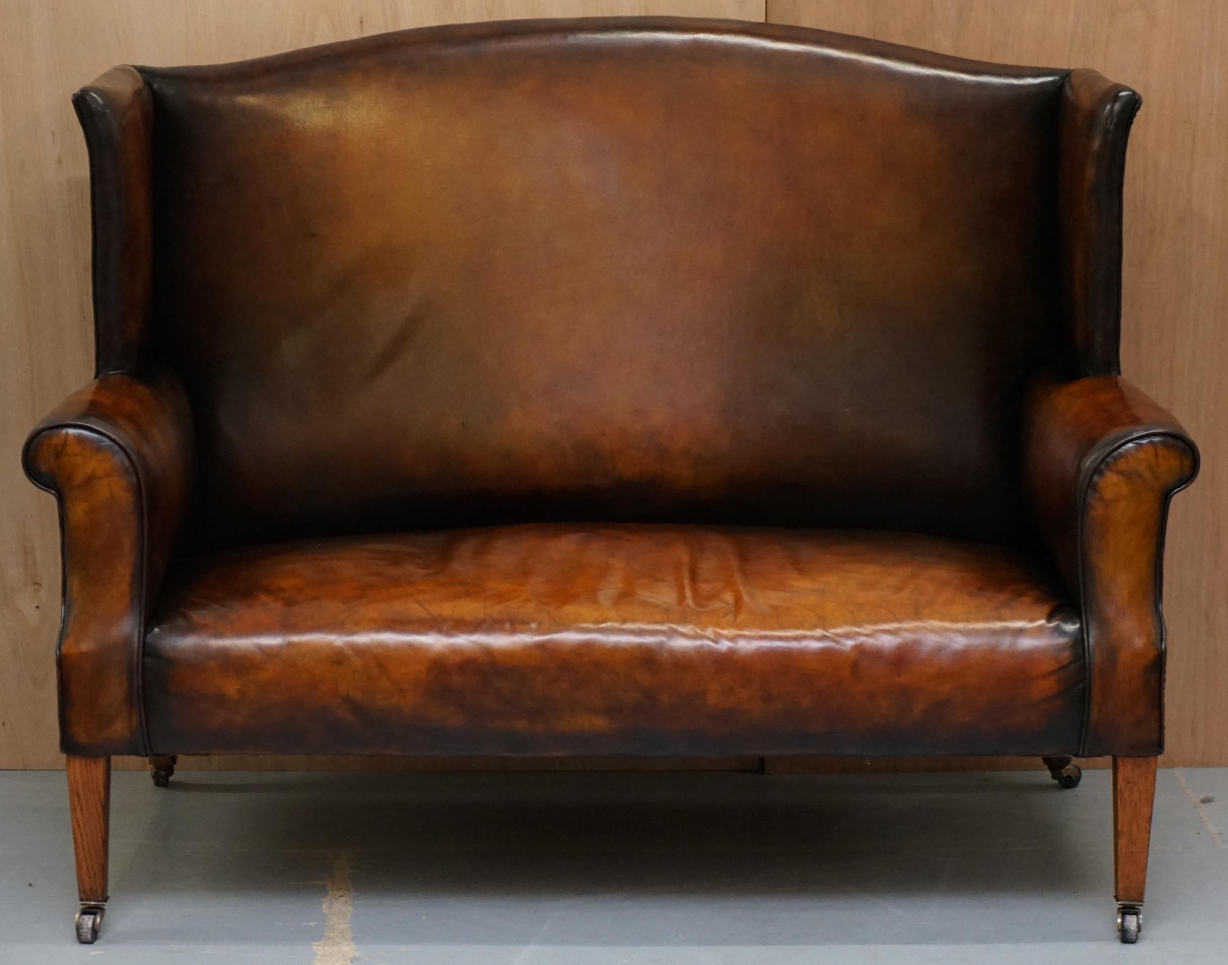We are delighted to offer for sale this stunning fully restored Victorian circa 1860 hand dyed Cigar brown leather Wingback sofa

A very well made and comfortable piece, the wingback armchair in essence goes back to the early Georgian era, the