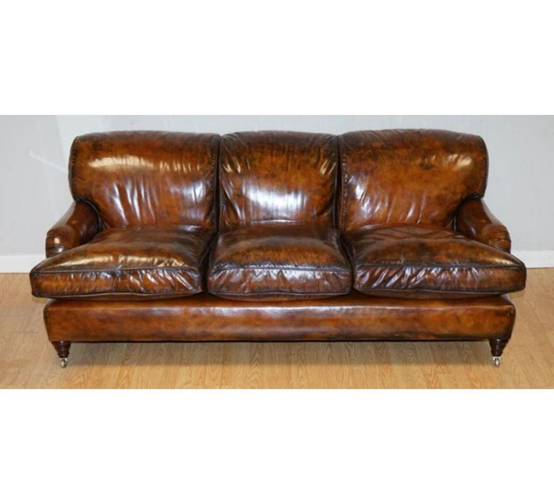 We are delighted to offer for sale this Gorgeous vintage brown leather hand-dyed Howards & Sons Style three seater sofa. 

Very good looking and timeless model sofa. The back cushions are sewn onto the couch and are filled with goose feathers. The