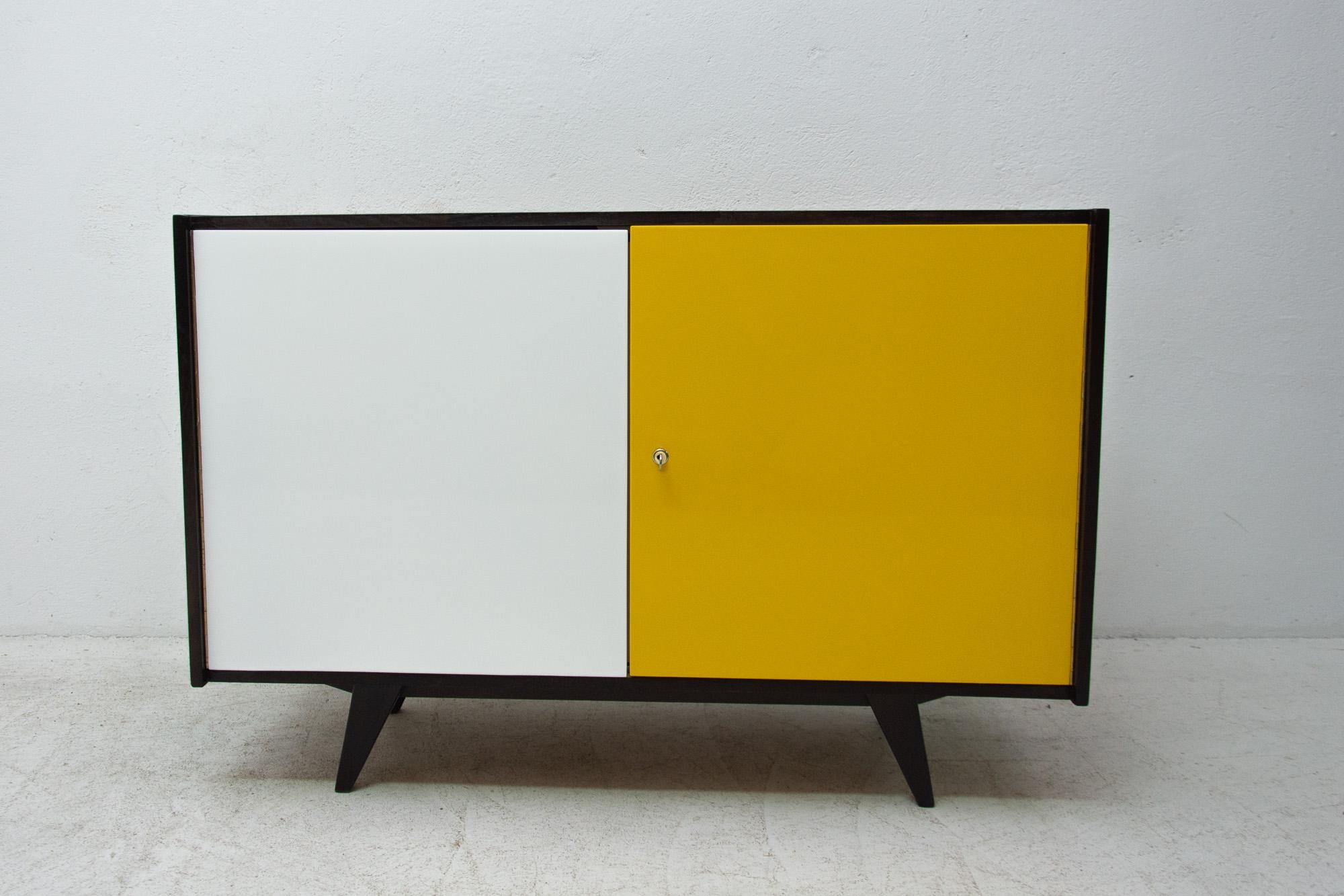 Midcentury sideboard-cabinet, catalogue No. U-450, designed by Jiri Jiroutek. It´s made of beechwood, veneer, plywood and laminate. In excellent condition, fully refurbished. Dark stained surface.

The cabinet comes from the famous Universal