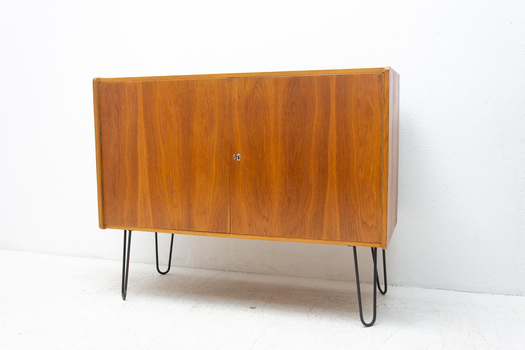 This upcycled mid-century sideboard-cabinet, catalogue No. U-450 was designed by Jiri Jiroutek for Interiér Praha. It´s made of beechwood, veneer, plywood and iron. Originally made with wooden legs, iron legs were used for this piece to increase
