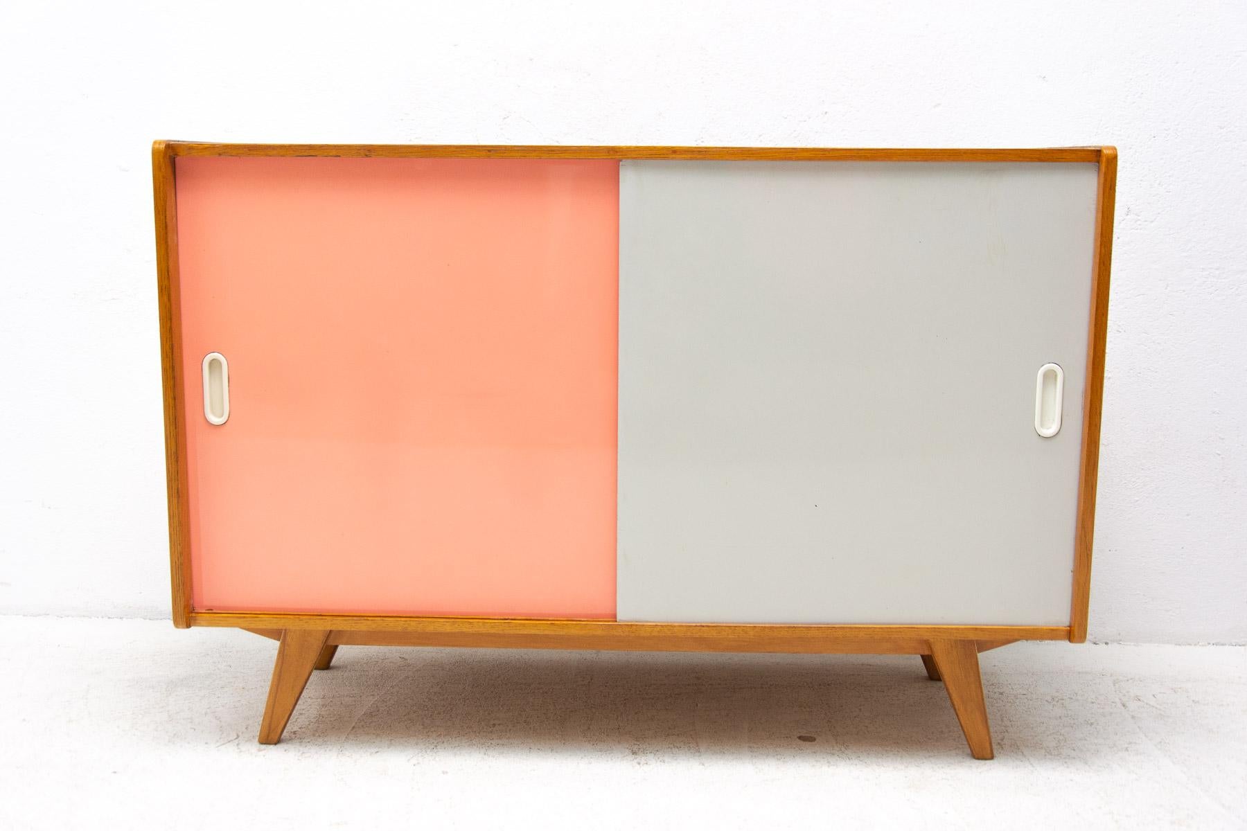 Mid century sideboard-cabinet with sliding doors, catalogue No. U-452, designed by Jiri Jiroutek. It´s made of beechwood, veneer, plywood and laminate. In excellent condition, fully refurbished.

The cabinet comes from the famous Universal series