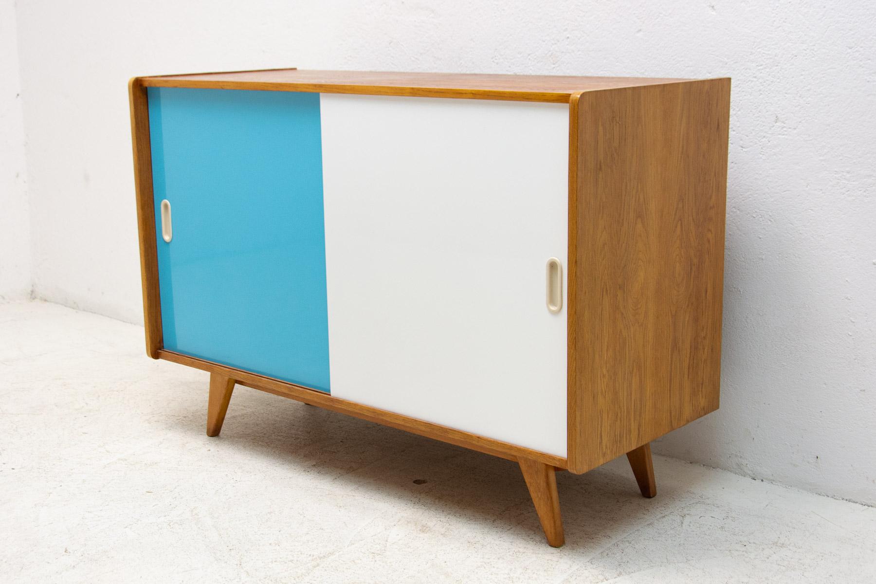 Mid century sideboard-cabinet with sliding doors, catalogue No. U-452, designed by Jiri Jiroutek. It´s made of beechwood, veneer, plywood and laminate. In excellent condition, fully refurbished.

The cabinet comes from the famous Universal series