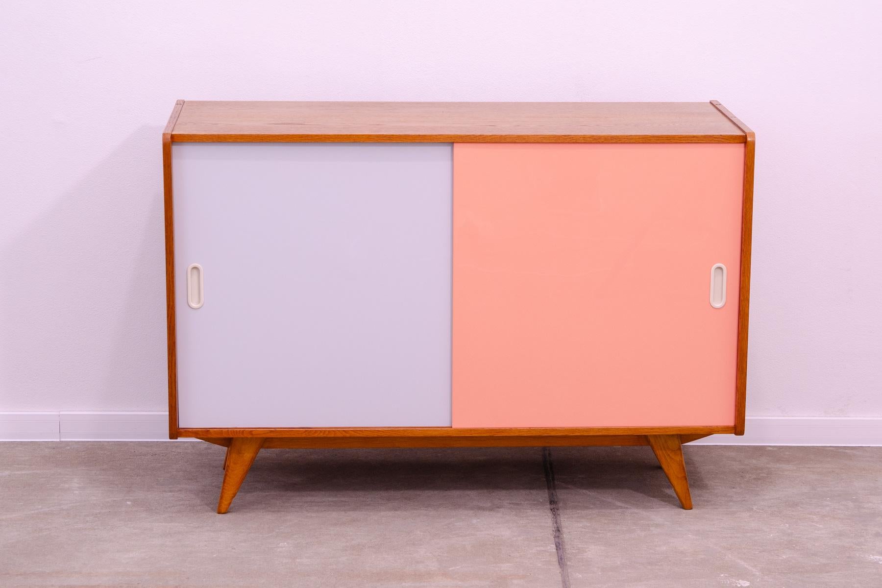 Mid century sideboard-cabinet with sliding doors, catalogue No. U-452, designed by Jiri Jiroutek. It´s made of beechwood, veneer, plywood and laminate. In excellent condition, fully refurbished.

The cabinet comes from the famous Universal series