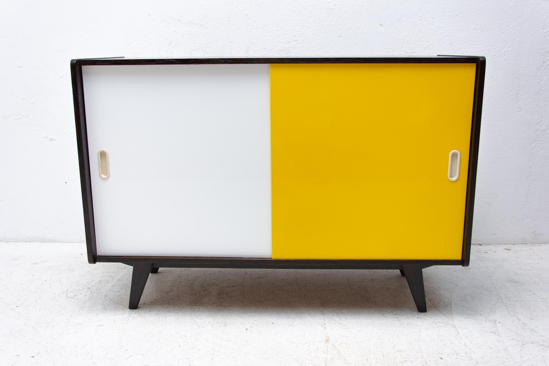 Midcentury sideboard-cabinet with sliding doors, catalogue No. U-452, designed by Jiri Jiroutek. It´s made of beechwood, veneer, plywood and laminate. In excellent condition, fully refurbished.

The cabinet comes from the famous Universal series