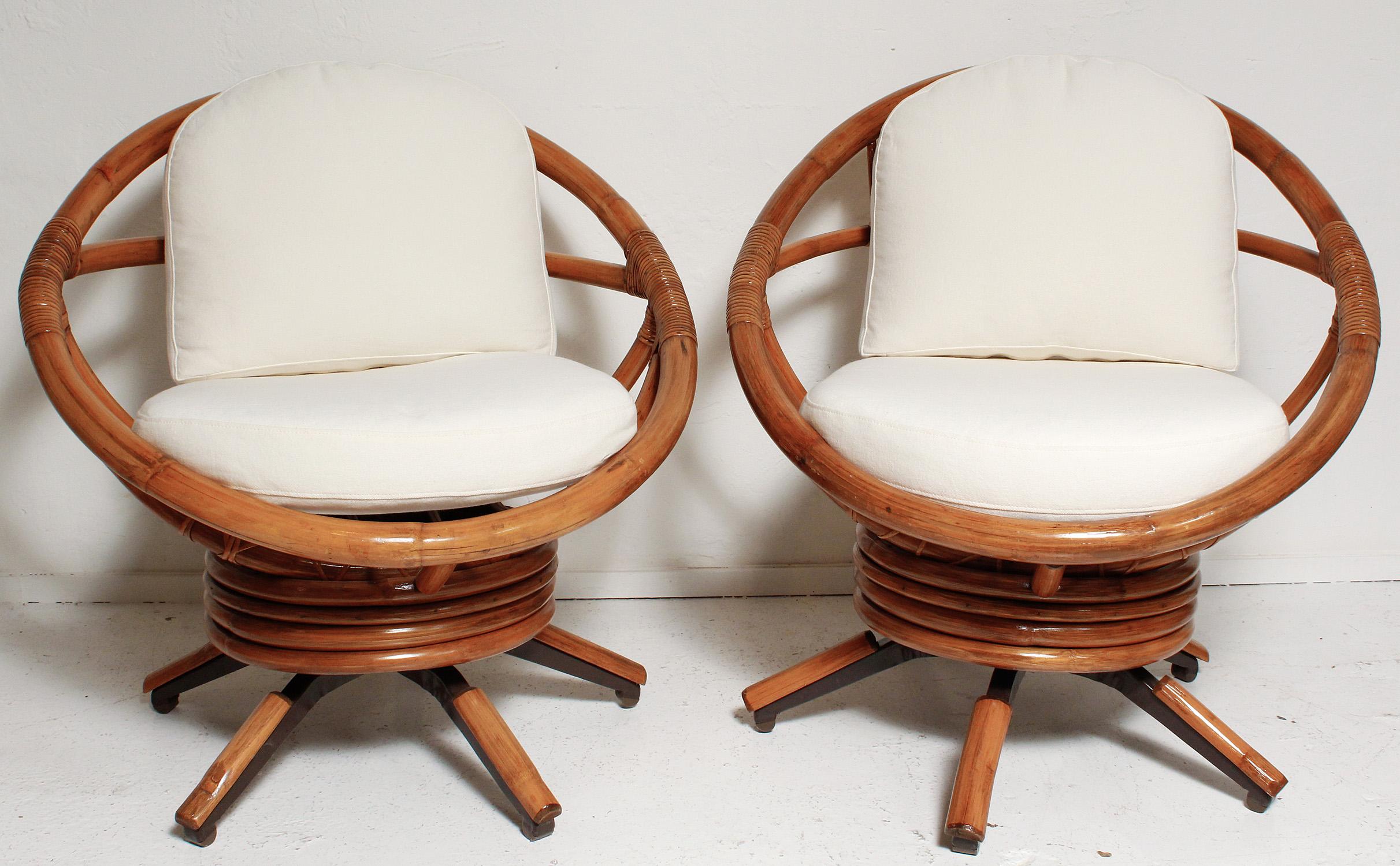 Swing out in this pair of fully restored bamboo swivel chairs with all new foam cushions and cotton twill upholstery.
