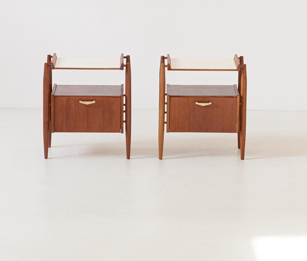 Set of two nightstands, manufactured in Italy, 1950s. 

These two side tables have two flap doors with brass handles
They are made of teak wood,
Fully restored, the original finishing was removed to bring the wood back to its original state ,