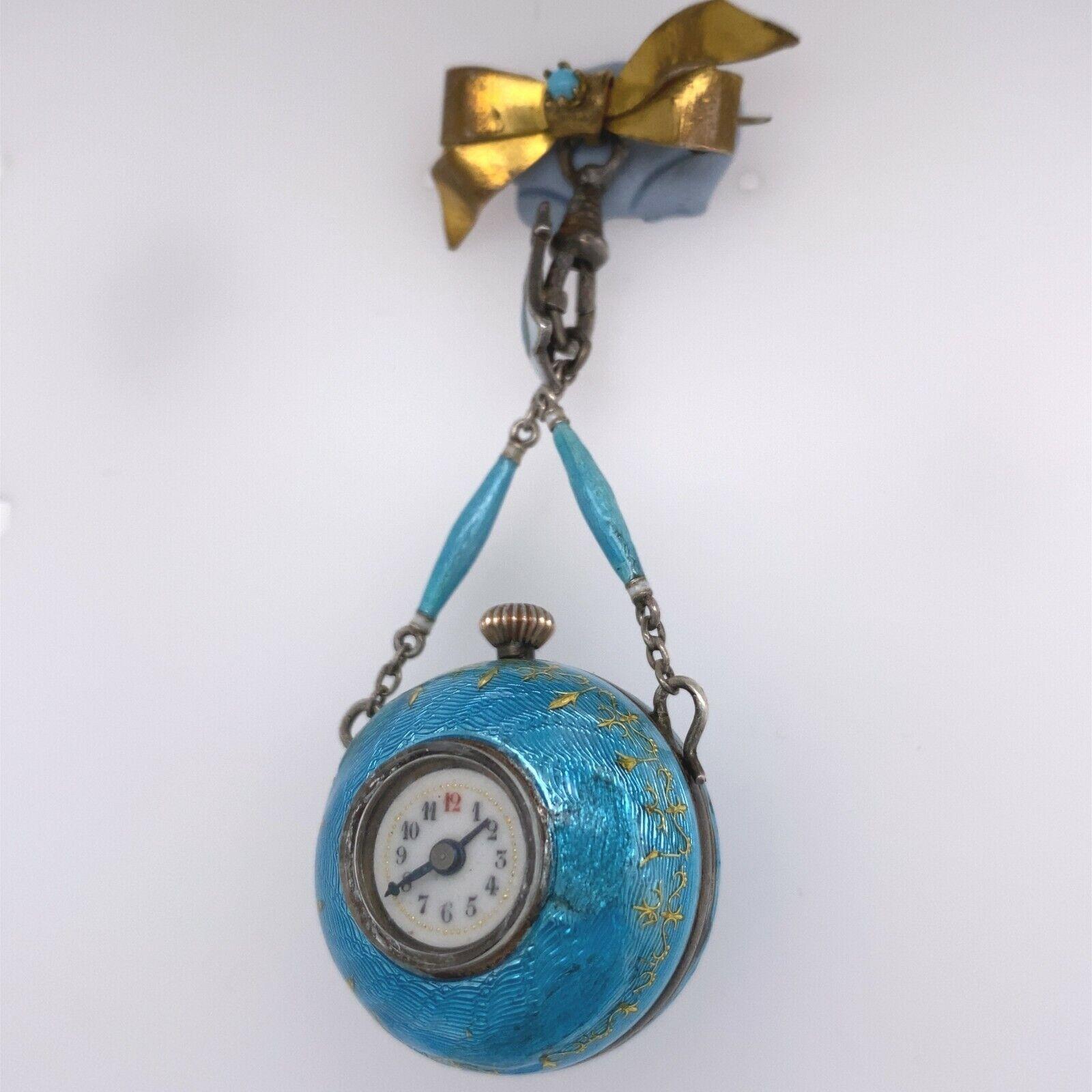 Fully Restored Turquoise Enamelled Ball Watch Suspended on a Bow Brooch

Additional Information:
Fully restored and in perfect working order. 
The ball is 26.3cm diameter. 
The brooch is 22.70cm x 12.50cm 
Water Resistance: Not Water Resistant