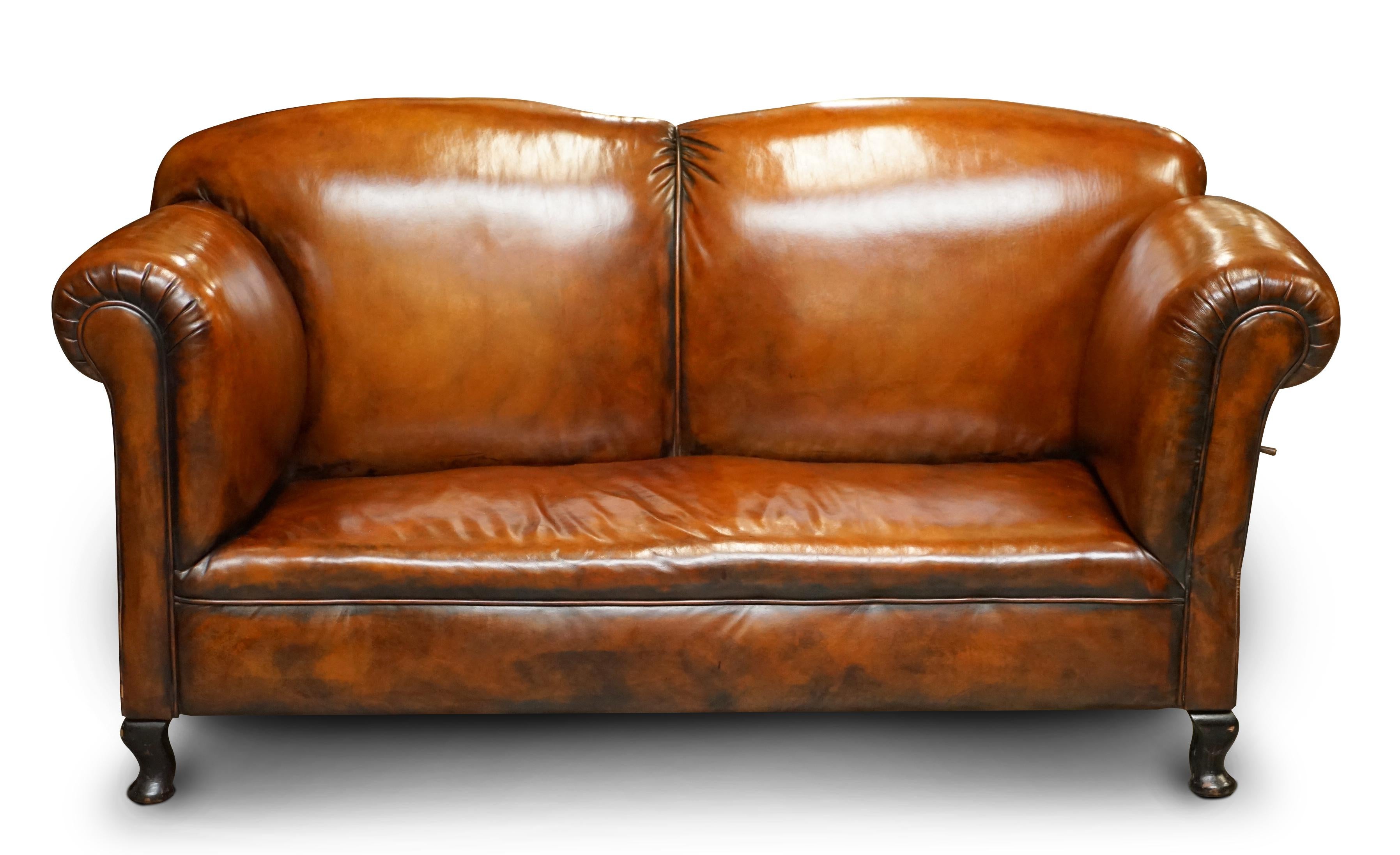 We are delighted to offer for sale this stunning fully restored Victorian drop arm sofa chaise lounge in hand dyed Whisky brown leather

A very good looking well made and comfortable sofa chaise. The seat platform is coil sprung with the original