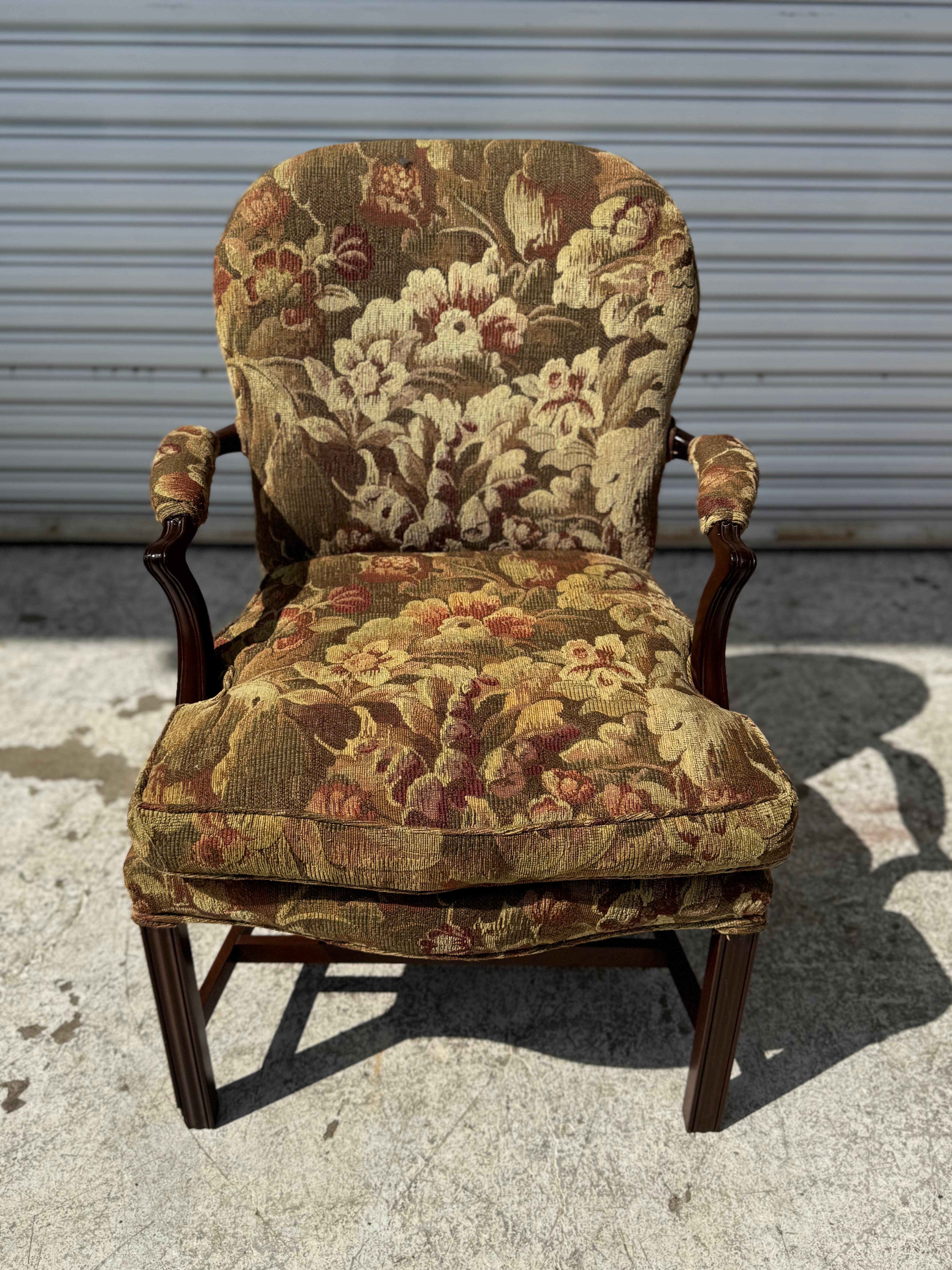This nicely upholstered armchair is in the Chippendale style.
It has upholstered arms for added comfort.
The legs and stretchers are made of walnut and it has a bowed front. 