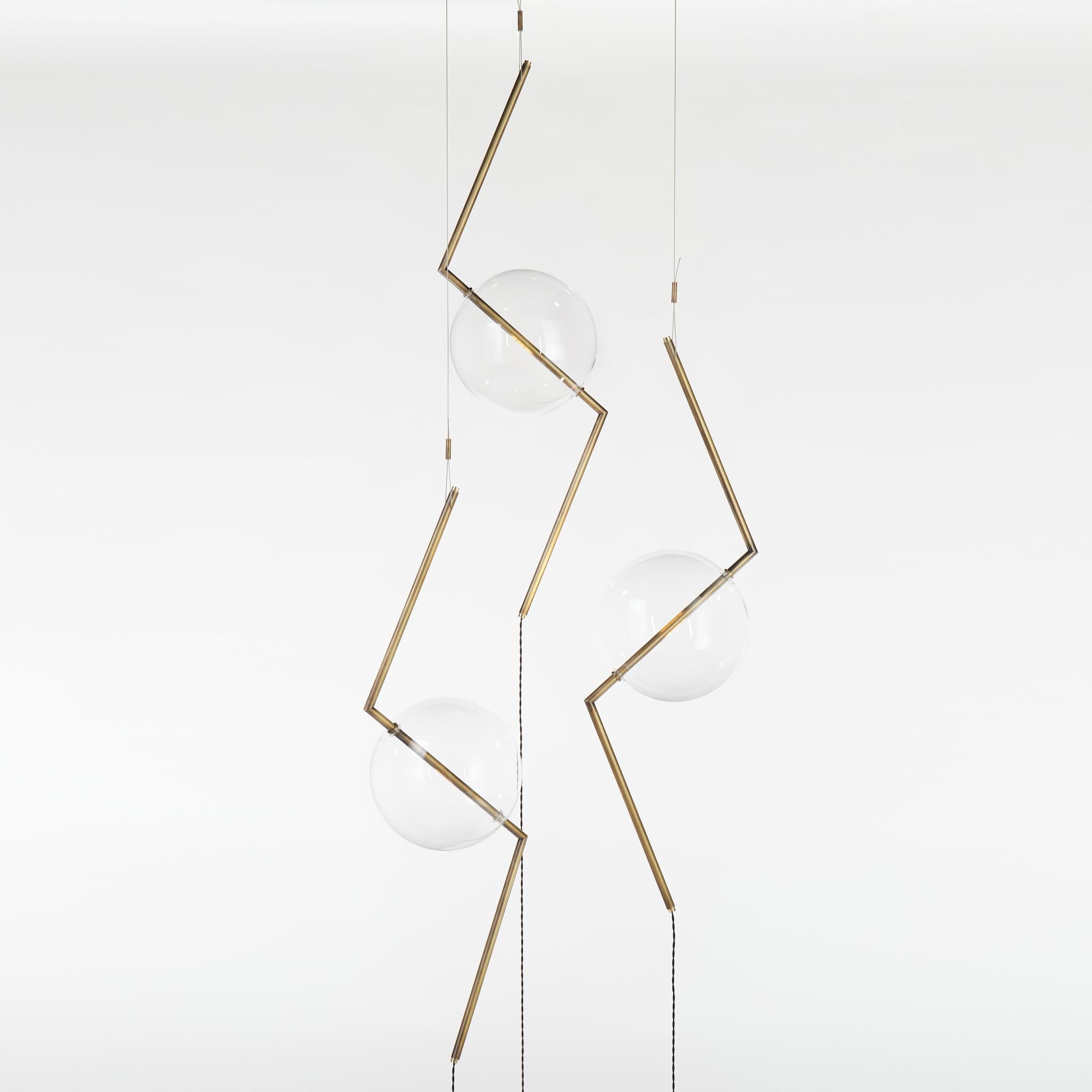 Somewhere between a suspension light and a floor lamp, Fulmine (thunderbolt) engages with gravity in an innovative and playful way. The central form, stretched from each end, seems to resist its own, emerging, lightning-bolt zig-zag Form, creating
