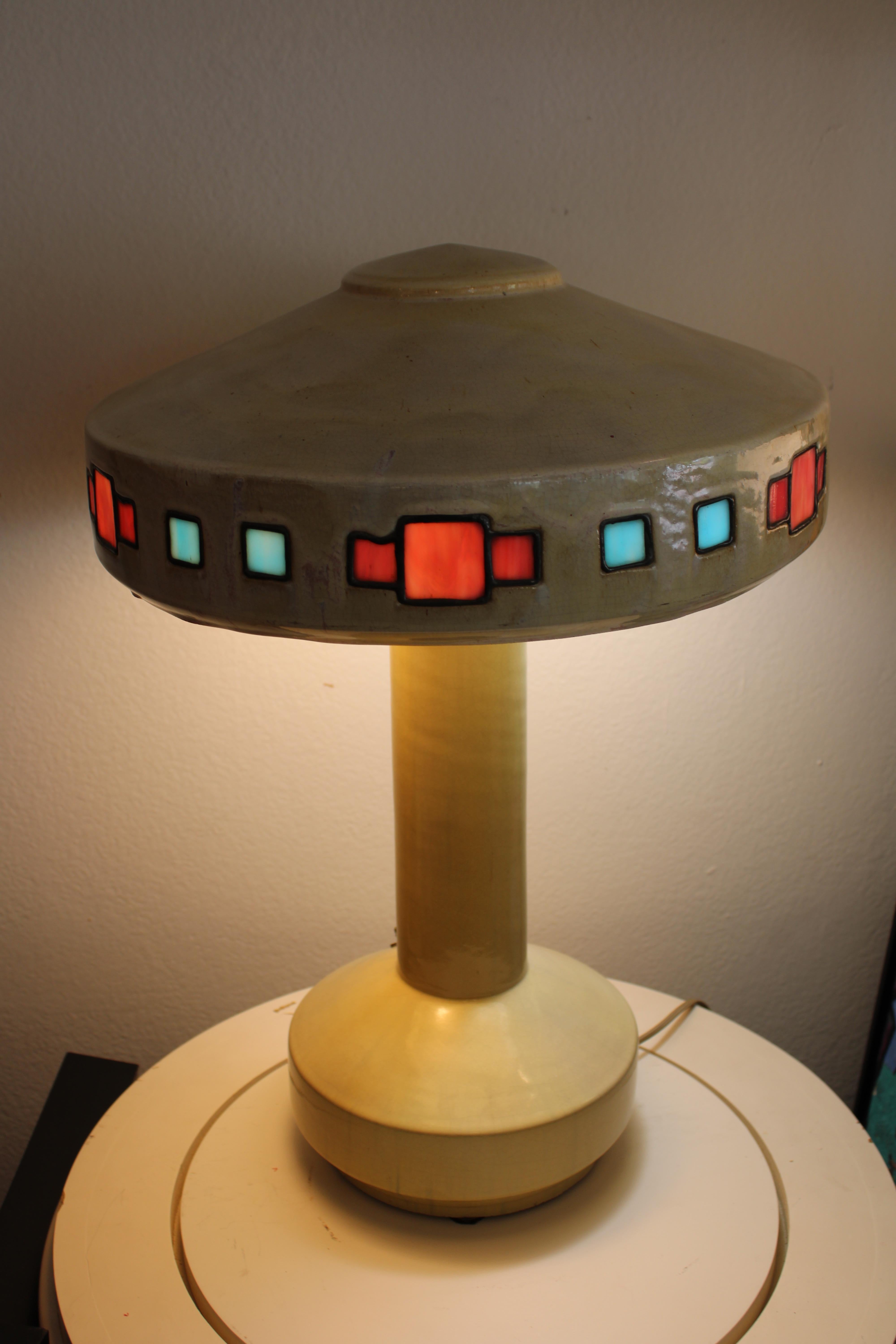 Cream colored flambe glazed stoneware and leaded glass lamp by Fulper.  Lamp measures 22