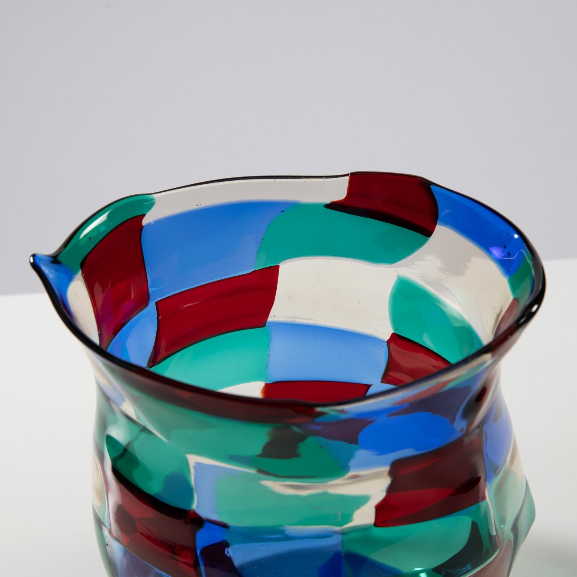 Murano mouth blown glass vase or bottle designed by Fulvio Bianconi for Venini in 1951. 
This variant of colors is often called by collectors “Paris”. 
It’s an arrangement of green, straw, red and blue mosaic tiles 

A rare shape characterized