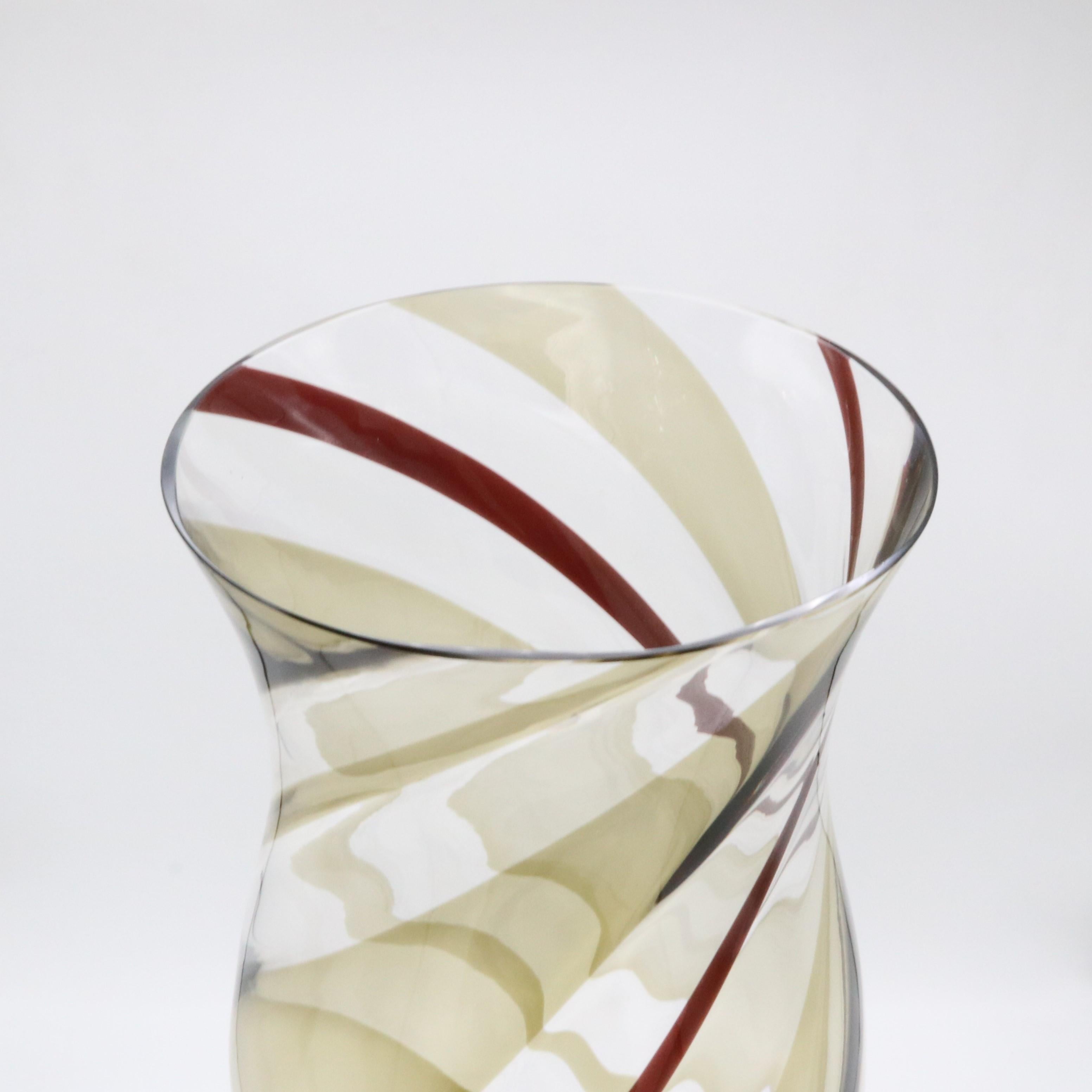 A tall Italian Art Glass vase attributed to Fulvio Bianconi for Venini from Italy circa 1950.  Clear cased glass with fused brown and purple spirals. Acid stamped underneath: Venini Murano Italia.